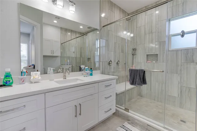 a bathroom with a shower and a sink