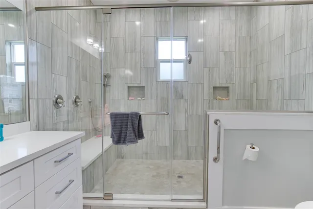 a bedroom with two beds and a window