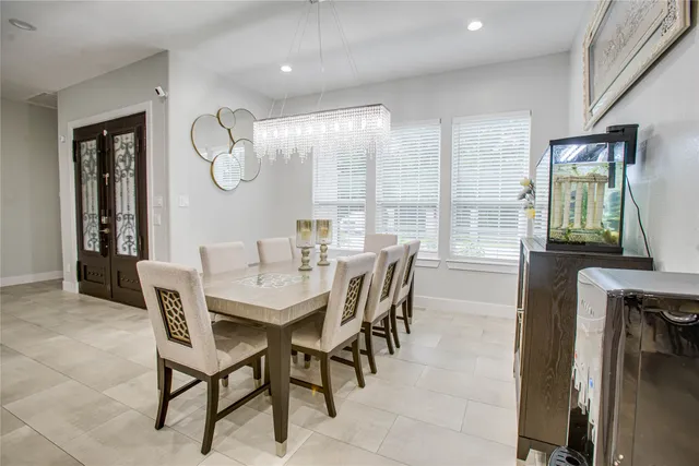 a dining room with furniture a rug and a large window