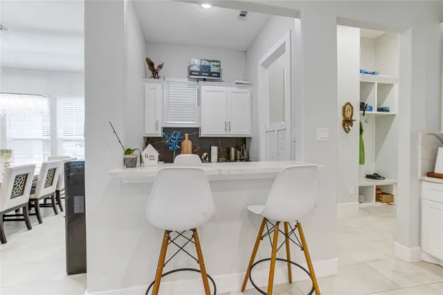a living room with furniture a dining table and a chandelier
