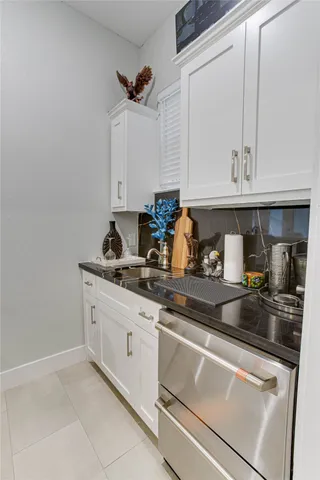 a kitchen with granite countertop a sink and cabinets