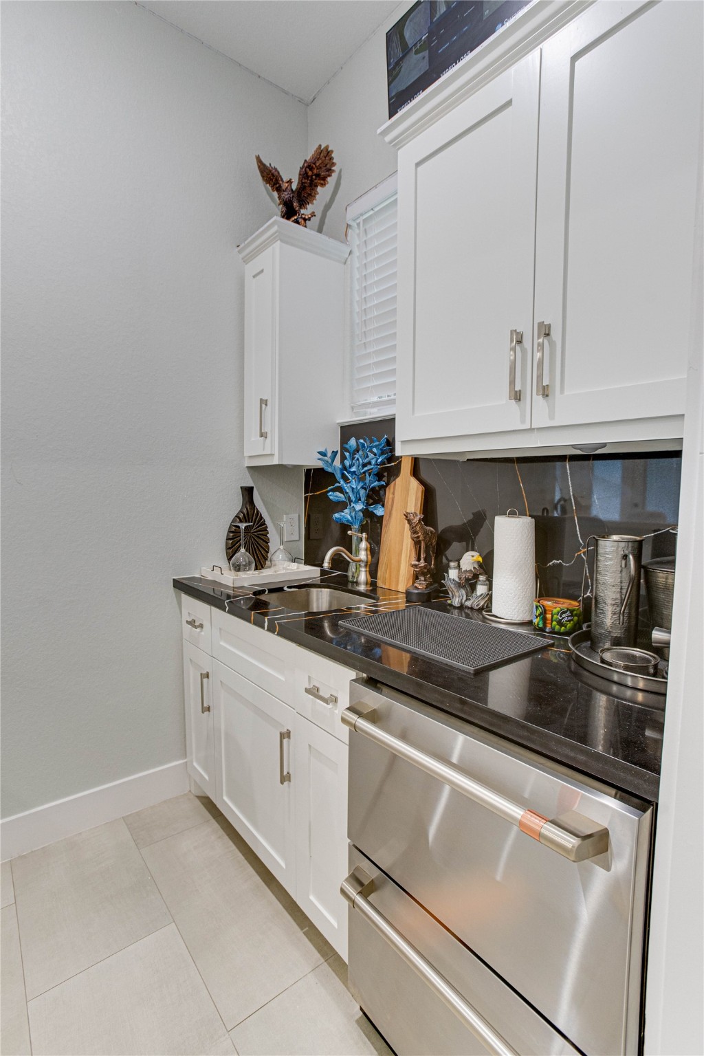 4821 1st Street Houston, TX 77504 - Photo 9 of 49 a kitchen with granite countertop a sink and cabinets