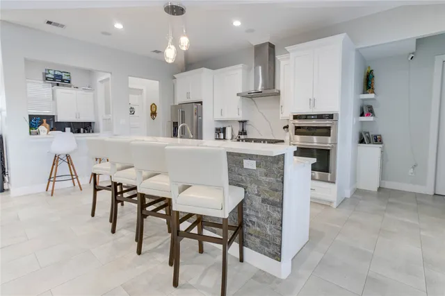 a kitchen with kitchen island cabinets and refrigerator