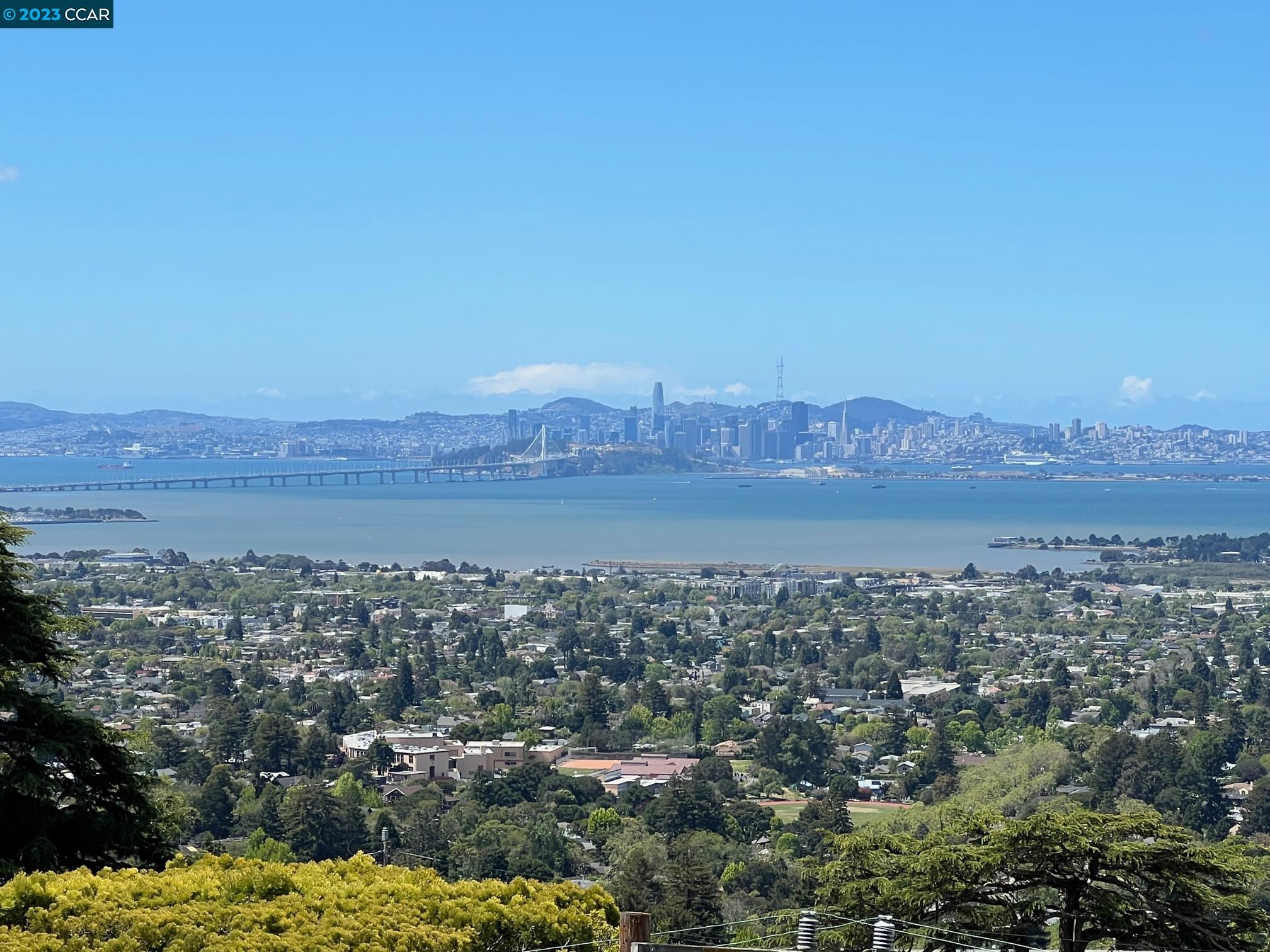 an aerial view of residential house and mountain view in back