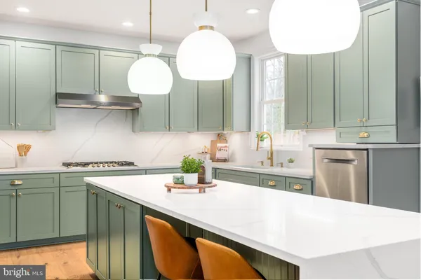 a kitchen with a sink a stove and cabinets