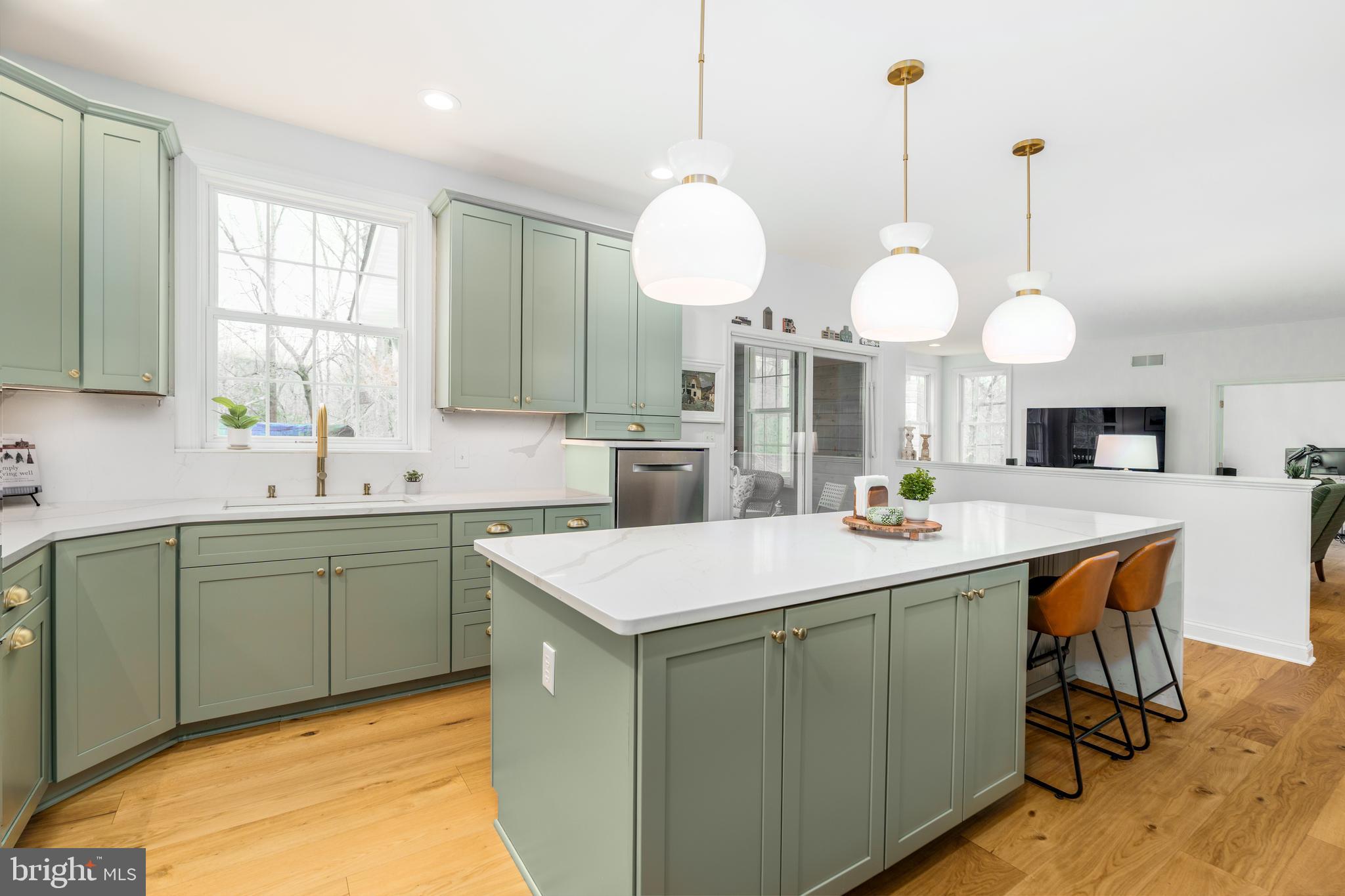31 Wood Chip Road Elkton, MD 21921 - Photo 5 of 42 a kitchen with kitchen island granite countertop a sink a stove and a chandelier