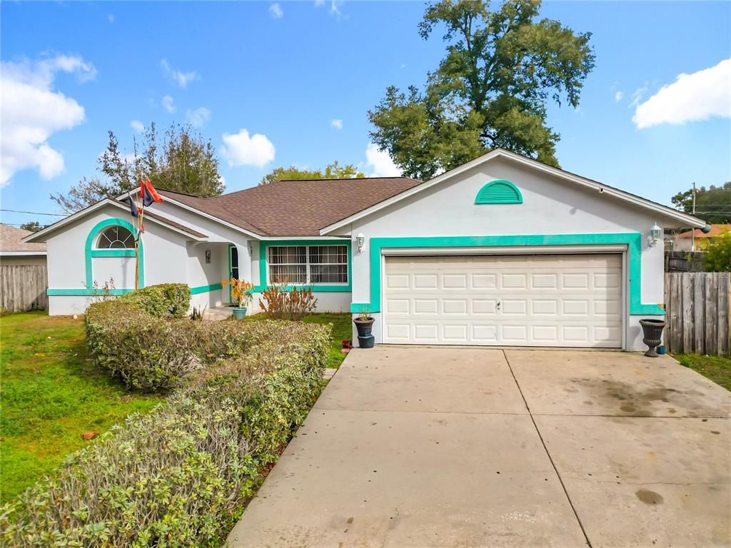 30 Hemlock Terrace Way Ocala, FL 34472 - Photo 1 of 44 a front view of a house with a yard and garage