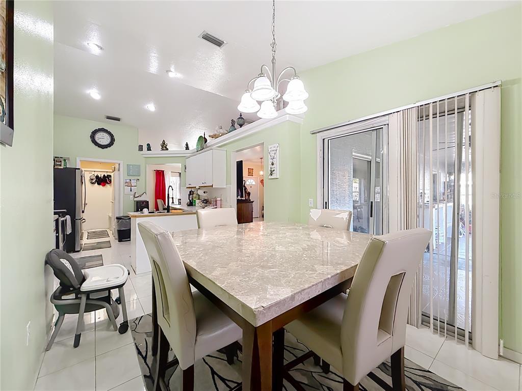 30 Hemlock Terrace Way Ocala, FL 34472 - Photo 12 of 44 a view of a dining area with furniture and a chandelier