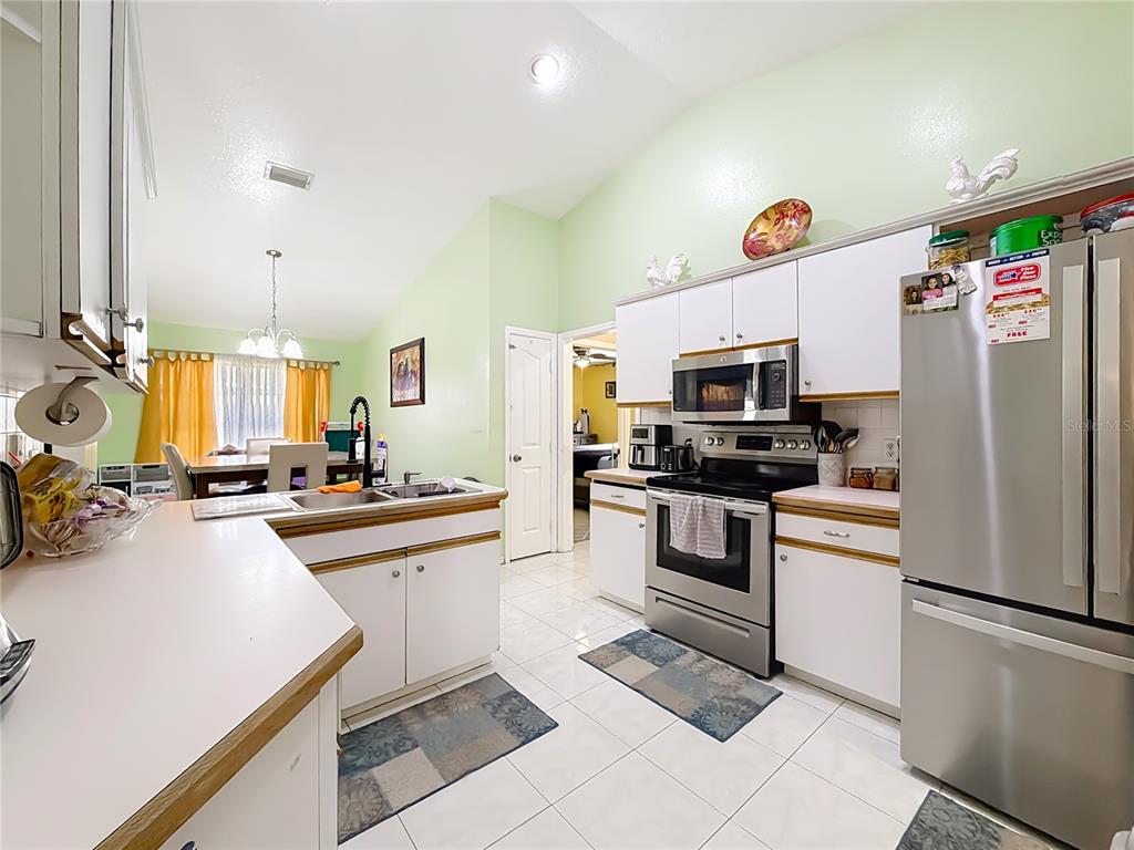 30 Hemlock Terrace Way Ocala, FL 34472 - Photo 18 of 44 a kitchen with a sink stainless steel appliances and white cabinets