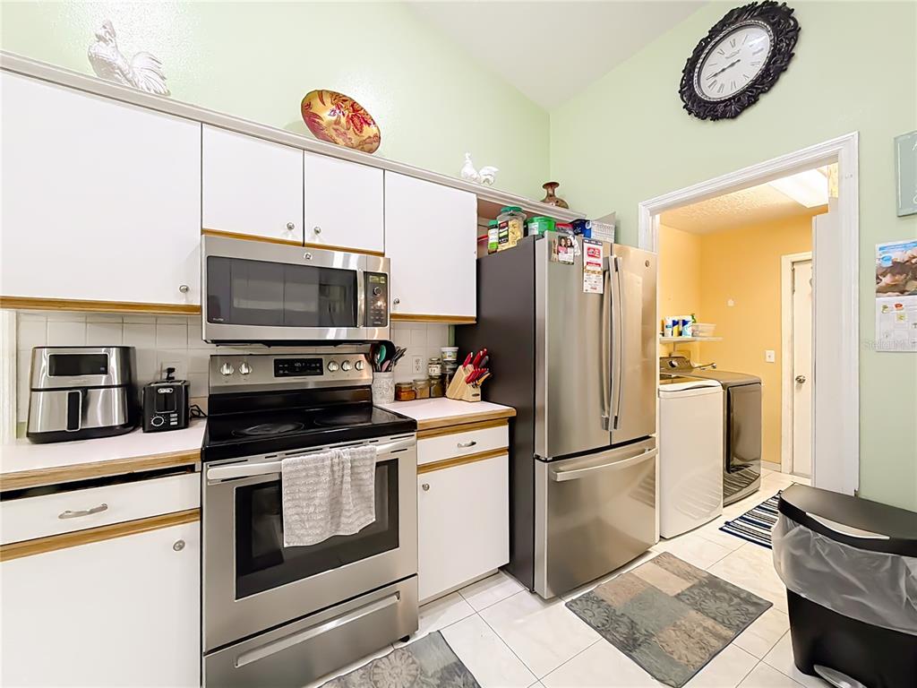 30 Hemlock Terrace Way Ocala, FL 34472 - Photo 19 of 44 a kitchen with stainless steel appliances a refrigerator stove and microwave