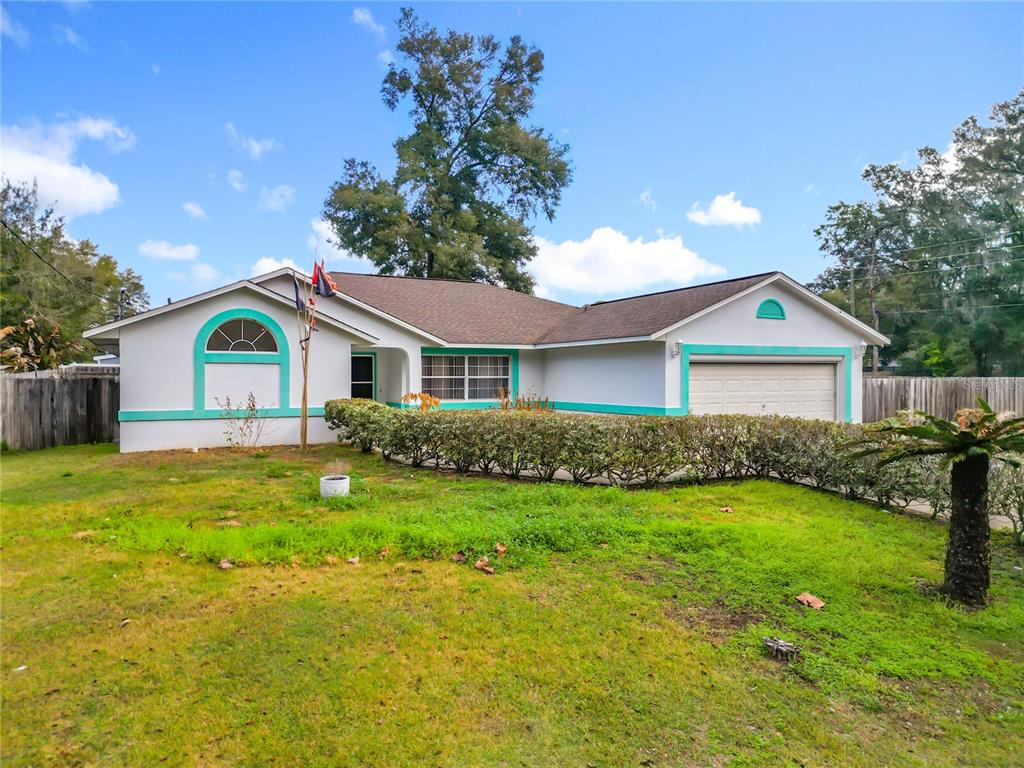30 Hemlock Terrace Way Ocala, FL 34472 - Photo 2 of 44 a front view of house with yard and green space