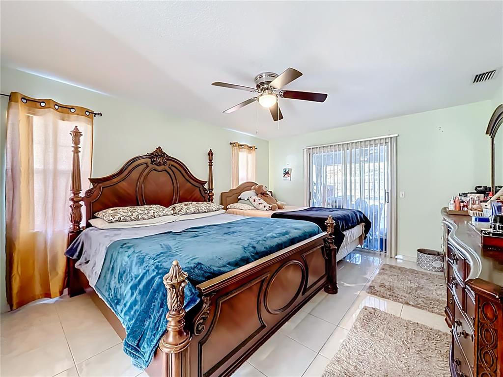 30 Hemlock Terrace Way Ocala, FL 34472 - Photo 26 of 44 a bed room with a bed and a chandelier