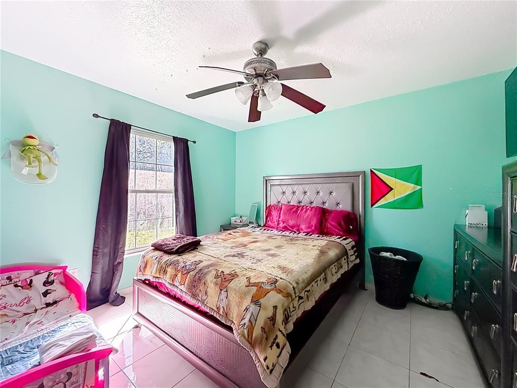 30 Hemlock Terrace Way Ocala, FL 34472 - Photo 27 of 44 a bedroom with a bed and a chandelier