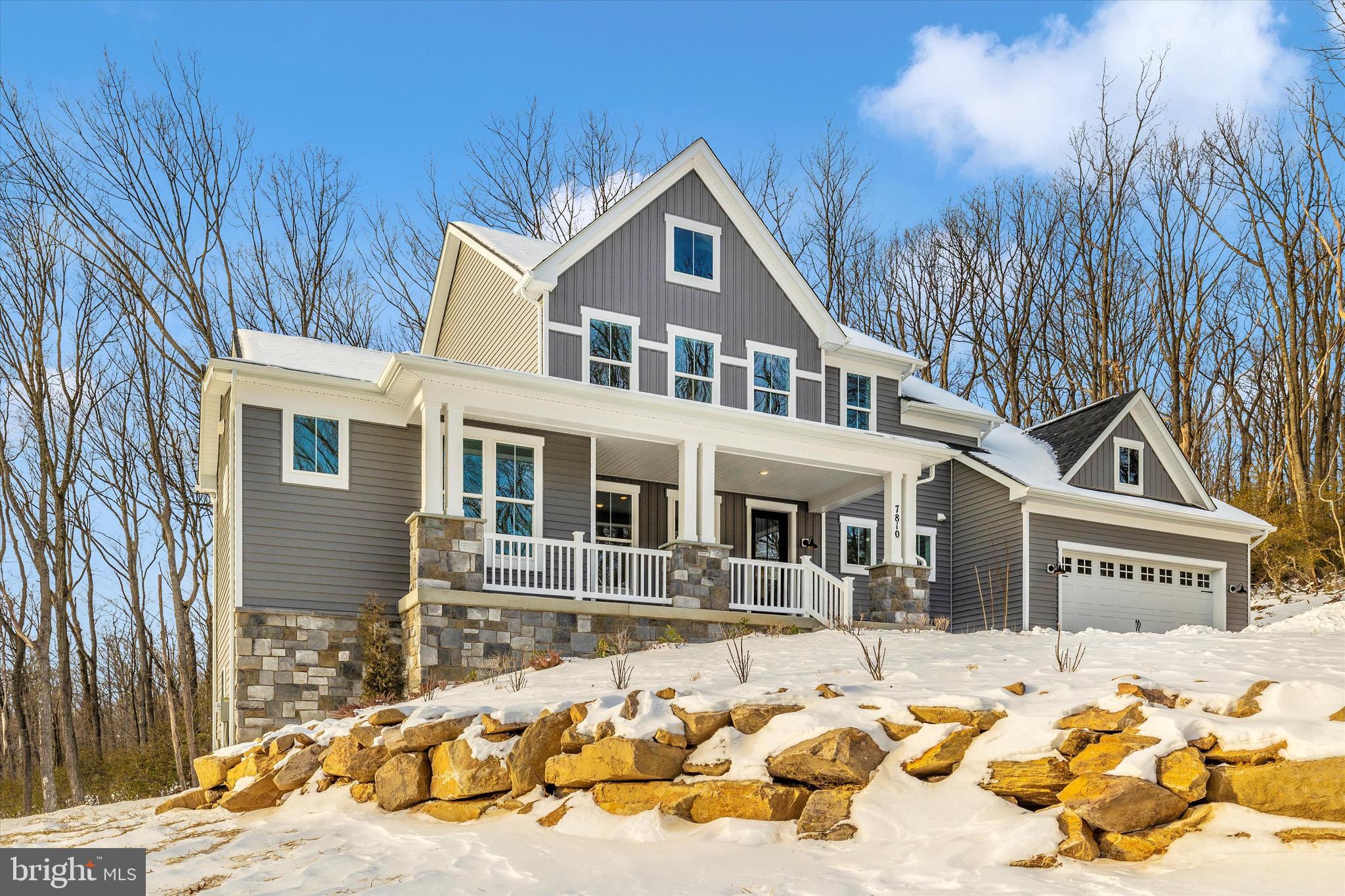 a front view of a house with snow on the road