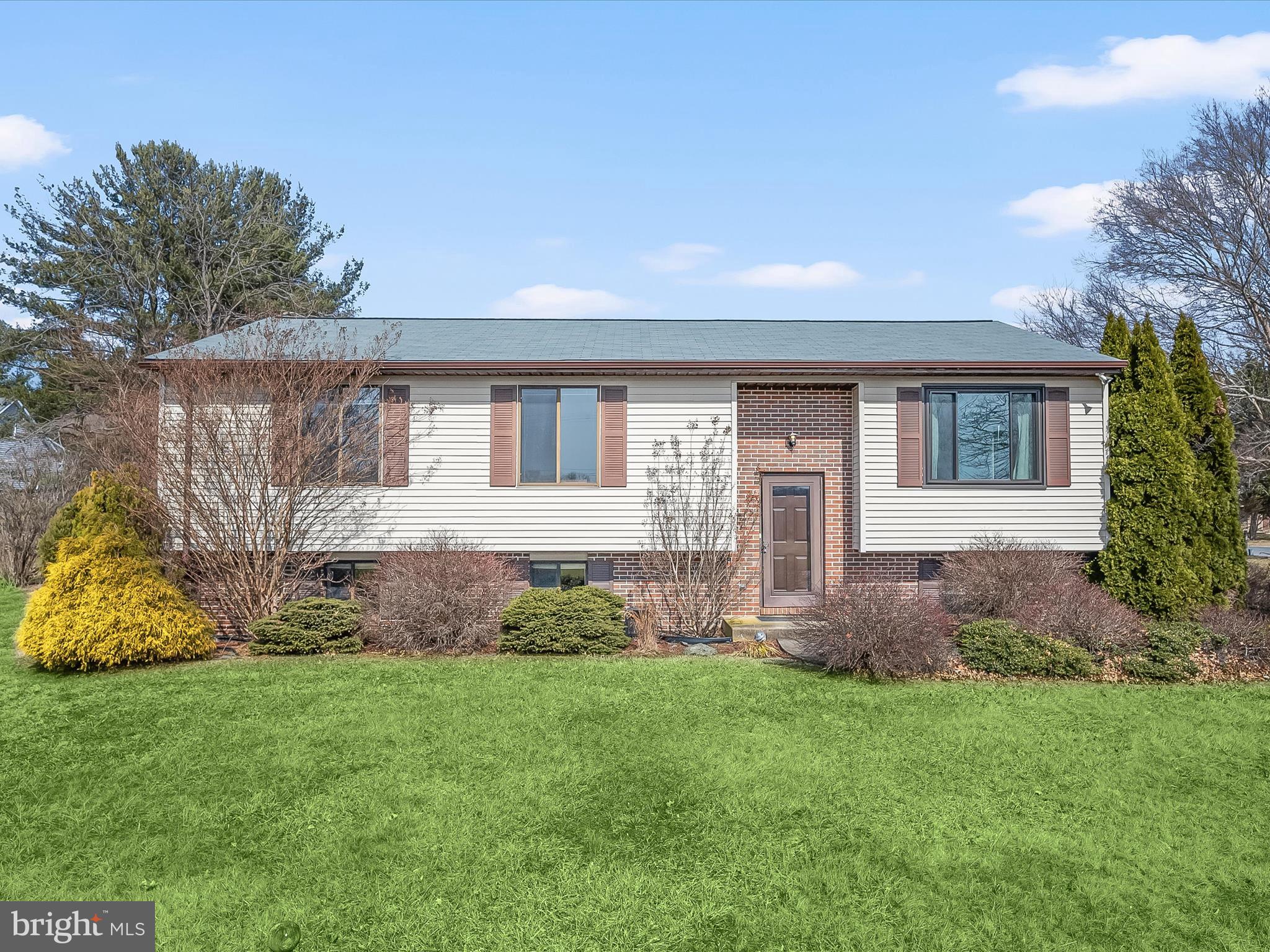 a front view of a house with a garden