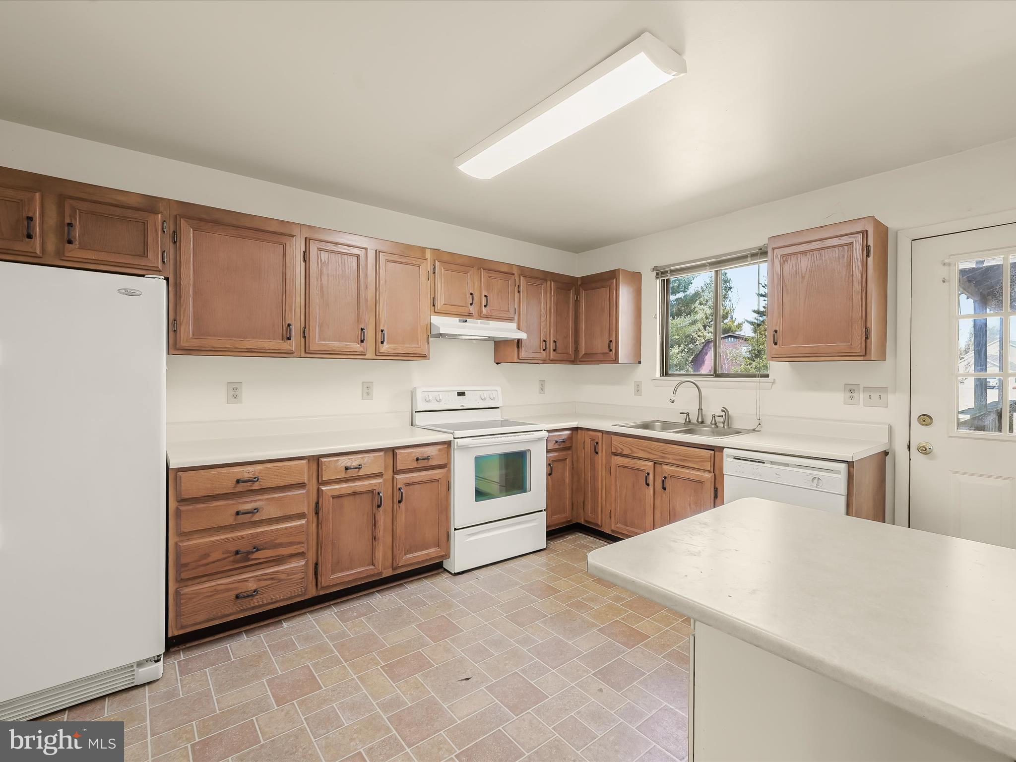 1100 Cedarbrook Road Hampstead, MD 21074 - Photo 12 of 46 a kitchen with granite countertop a sink stainless steel appliances and cabinets