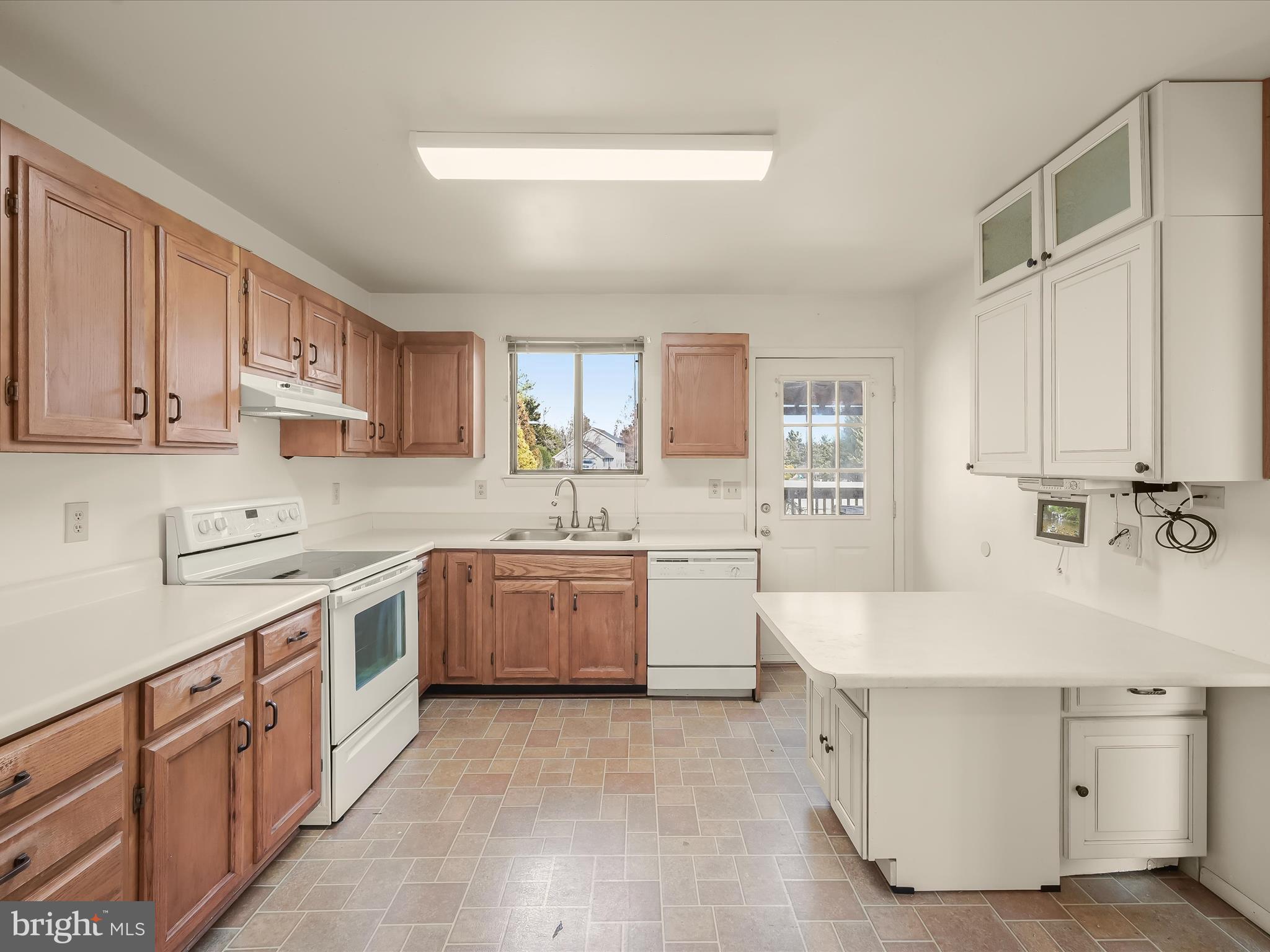 1100 Cedarbrook Road Hampstead, MD 21074 - Photo 13 of 46 a kitchen with a sink stove top oven and cabinets