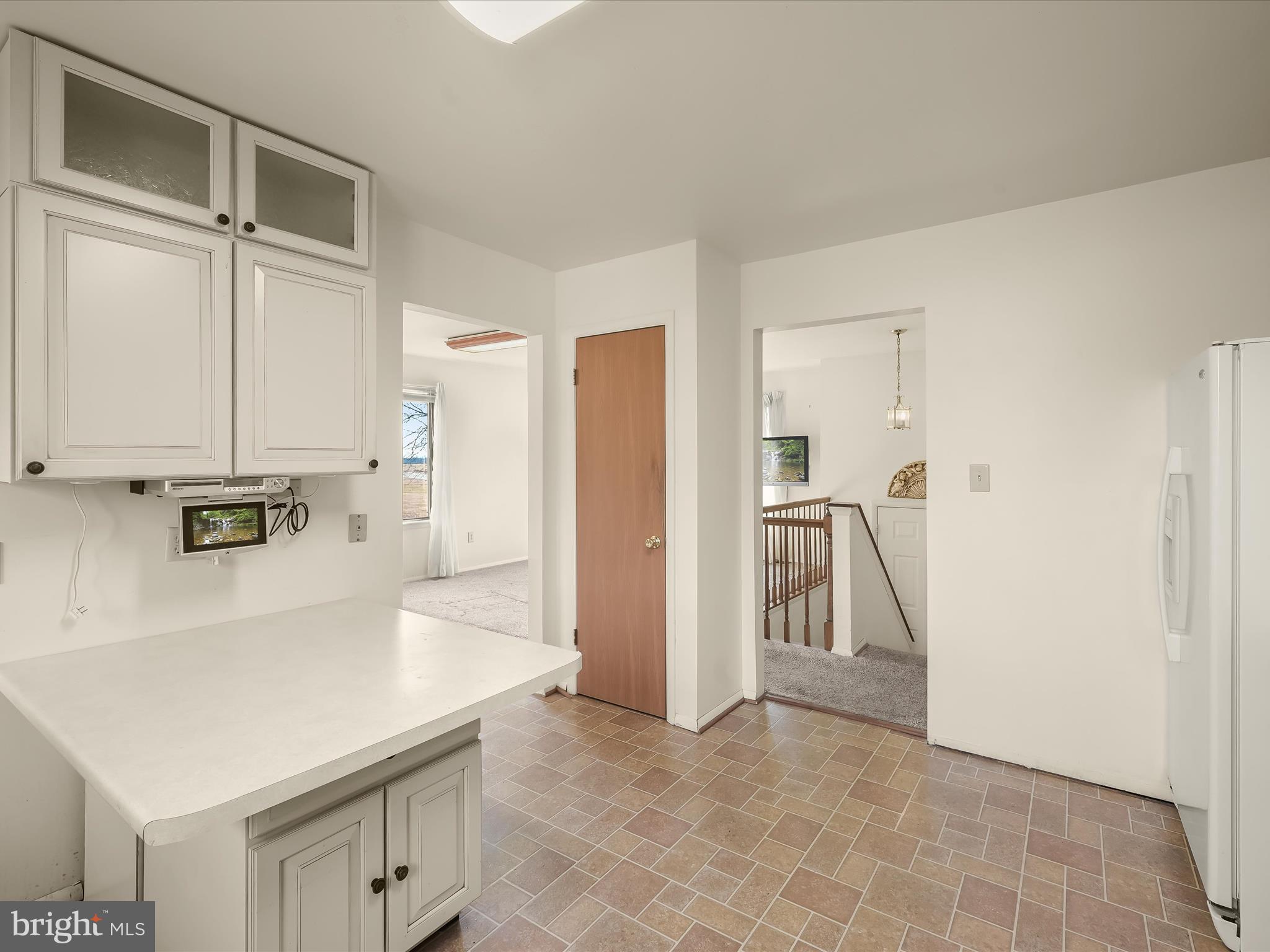 1100 Cedarbrook Road Hampstead, MD 21074 - Photo 14 of 46 a view of a refrigerator in kitchen and white cabinets