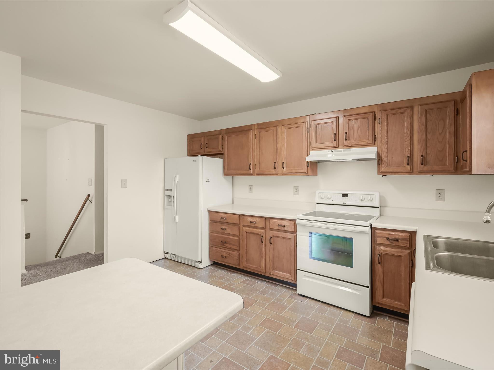 1100 Cedarbrook Road Hampstead, MD 21074 - Photo 15 of 46 a kitchen with a stove sink and cabinets
