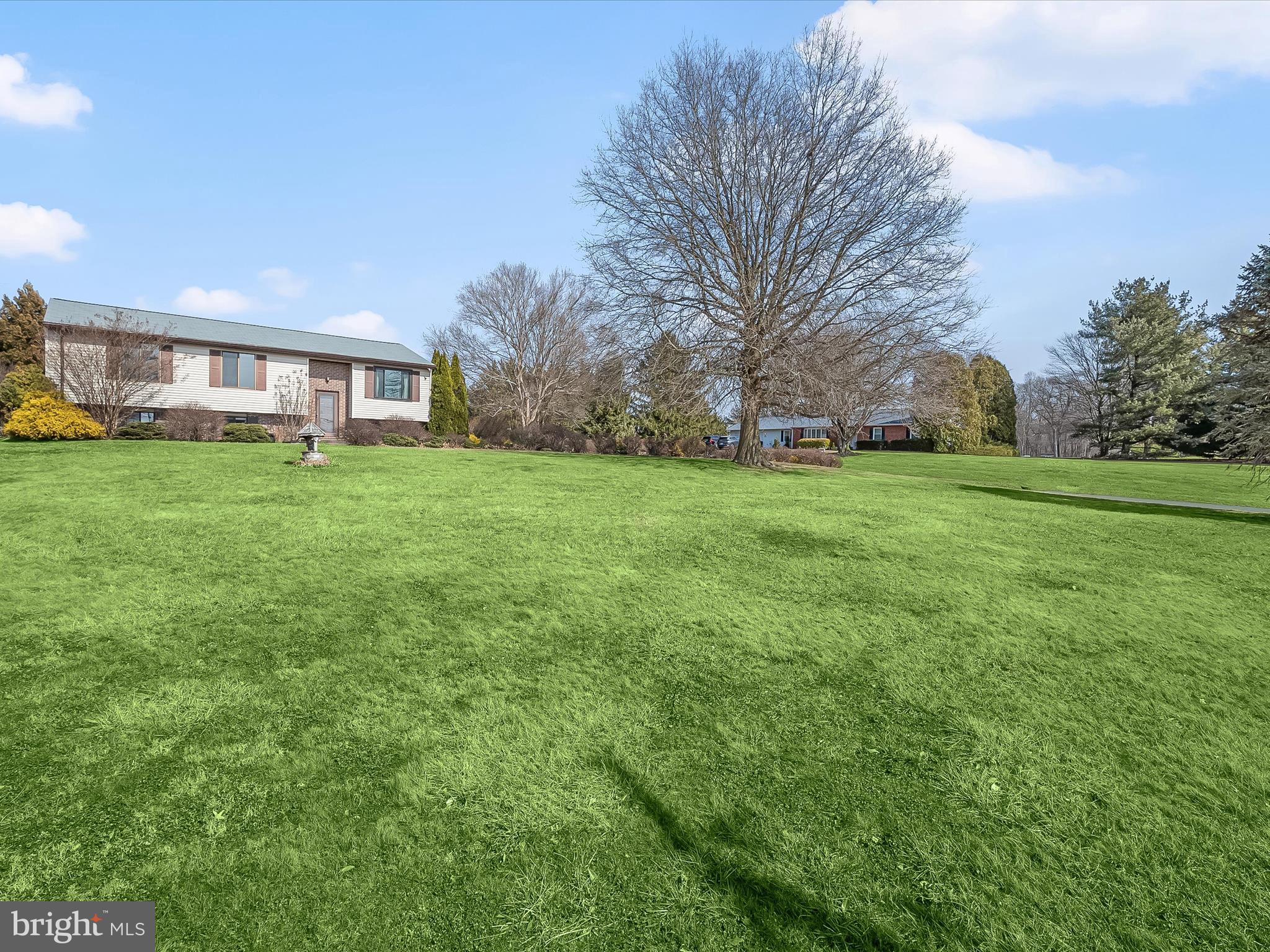 1100 Cedarbrook Road Hampstead, MD 21074 - Photo 2 of 46 a view of a big yard with a house in the background