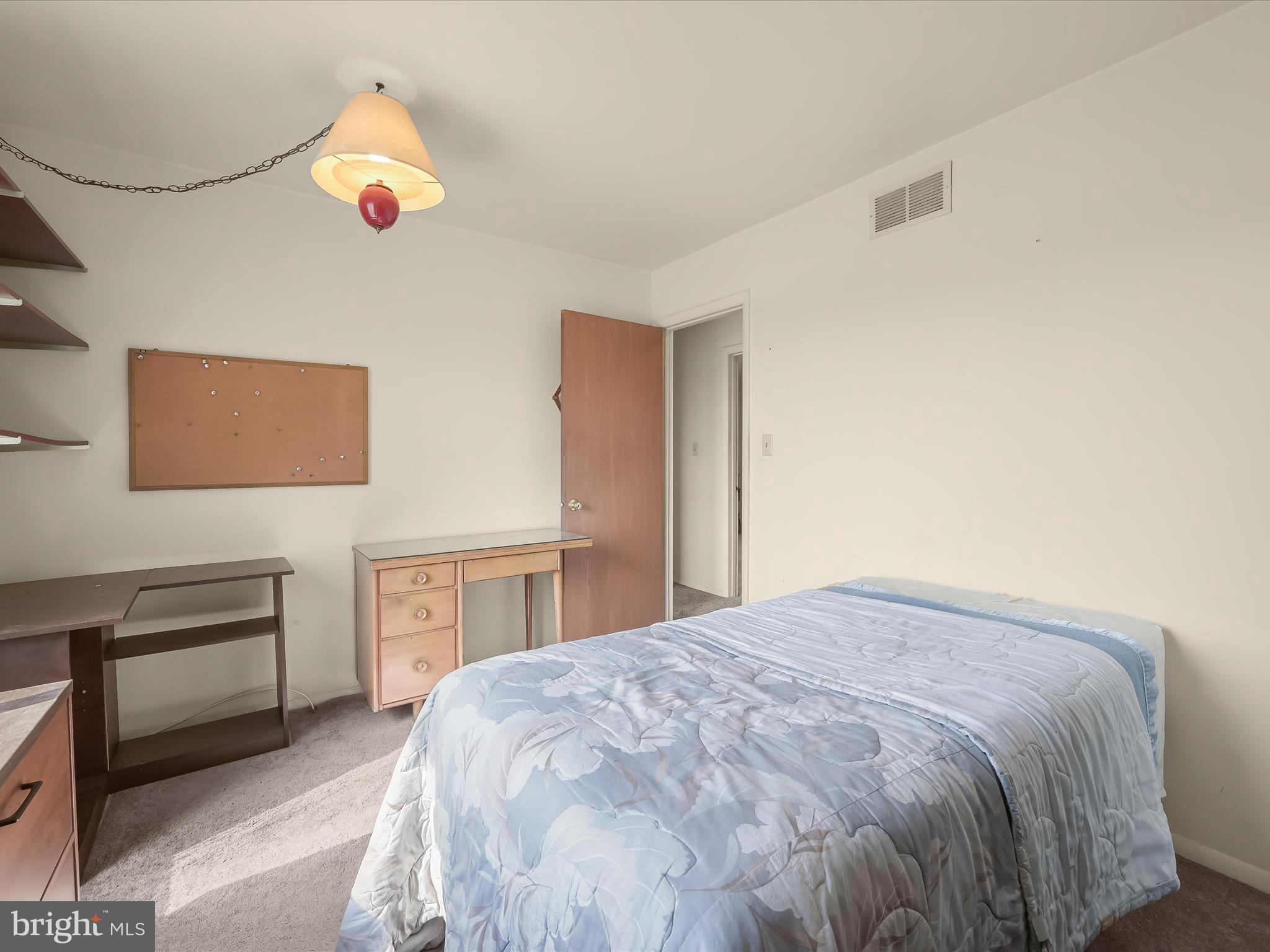 1100 Cedarbrook Road Hampstead, MD 21074 - Photo 25 of 46 a bedroom with a bed and a chandelier