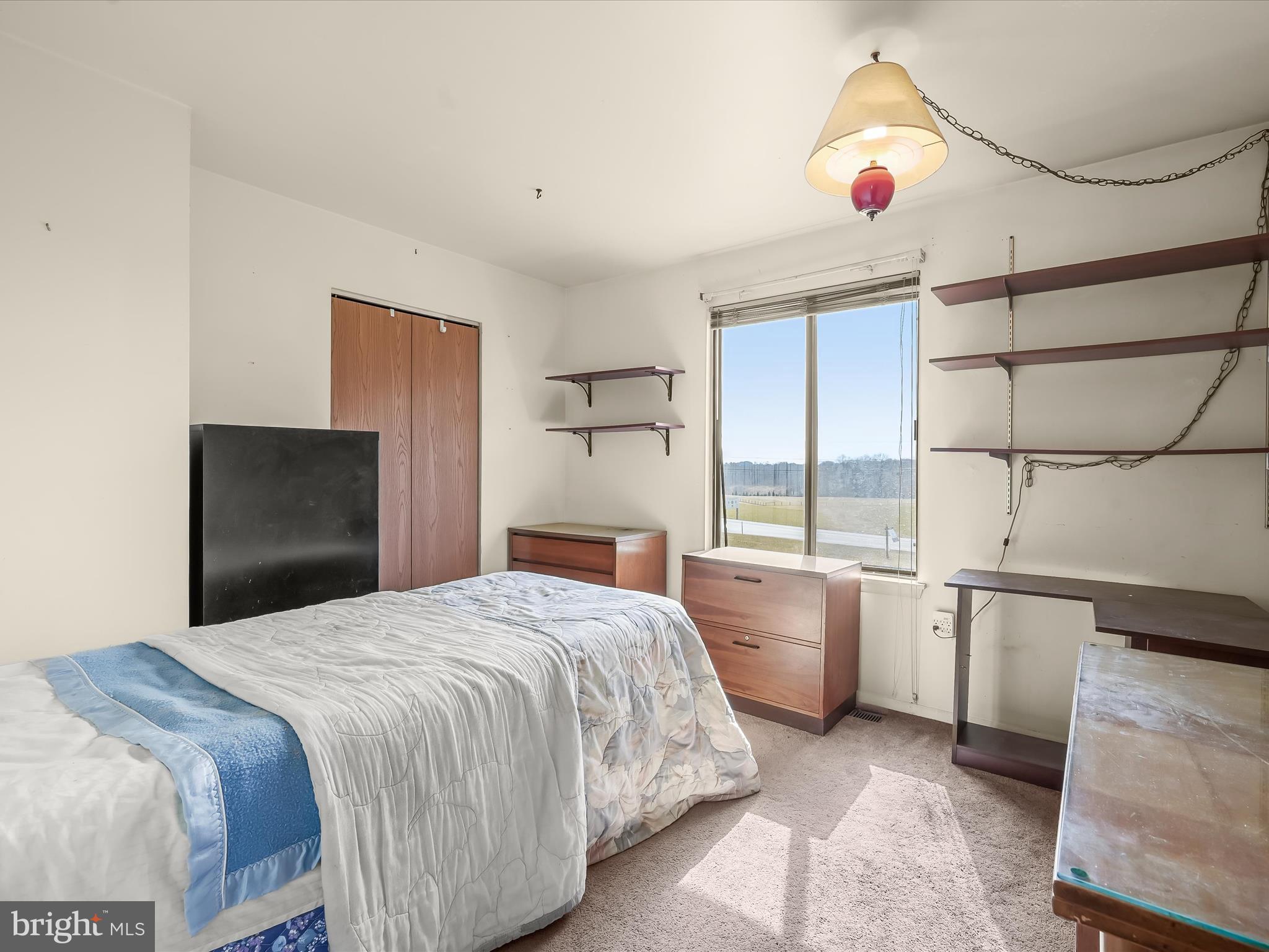 1100 Cedarbrook Road Hampstead, MD 21074 - Photo 26 of 46 a bedroom with a bed and a chandelier