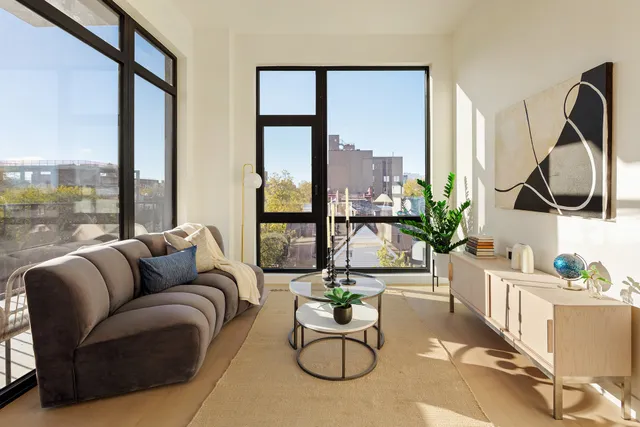 a living room with furniture and a large window