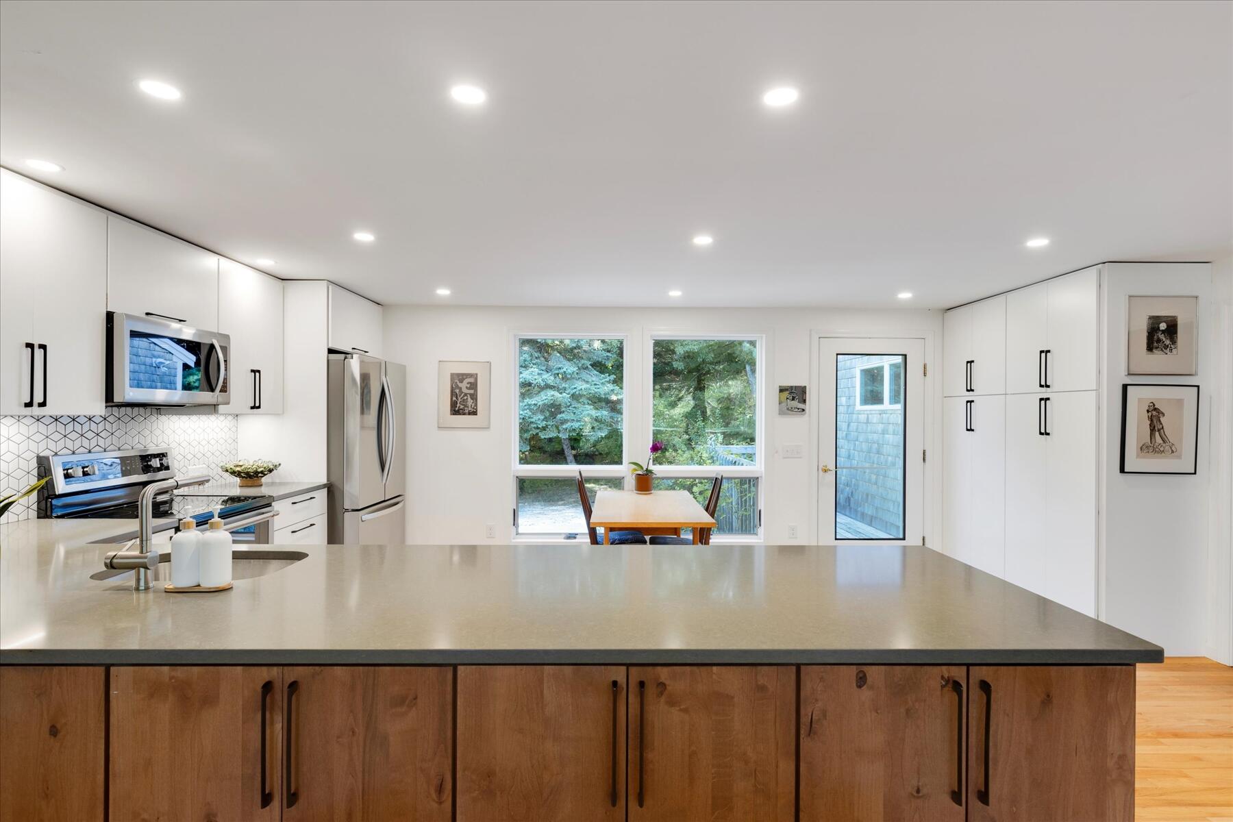 225 Coles Neck Road Wellfleet, MA 02667 - Photo 14 of 51 a kitchen with a large window appliances and cabinets