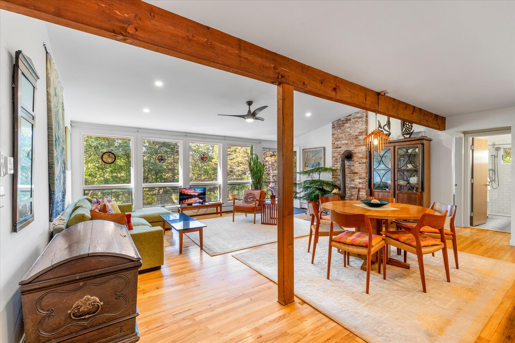 225 Coles Neck Road Wellfleet, MA 02667 - Photo 15 of 51 a living room filled with furniture and floor to ceiling windows