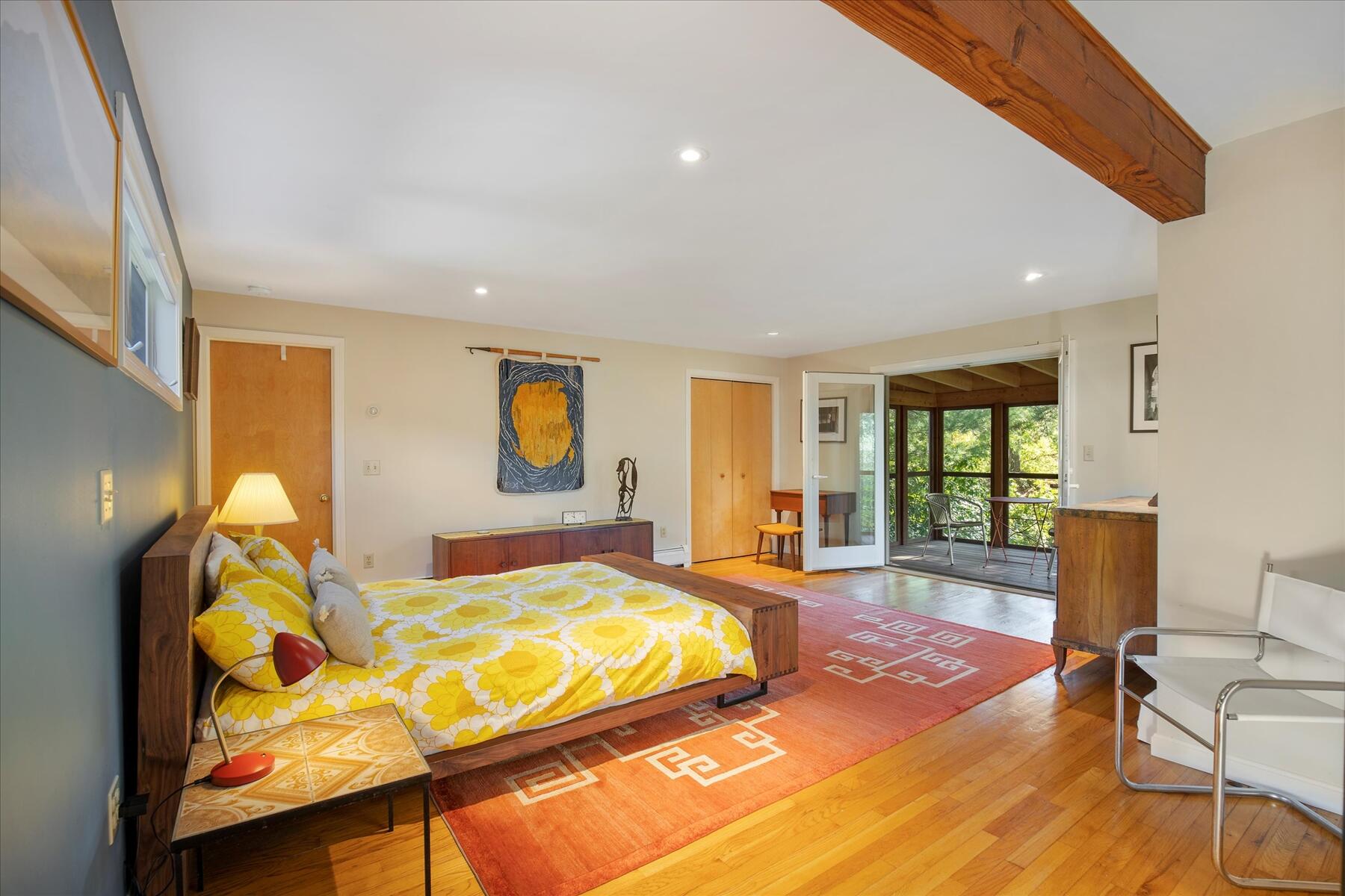 225 Coles Neck Road Wellfleet, MA 02667 - Photo 19 of 51 a spacious bedroom with a bed and wooden floor