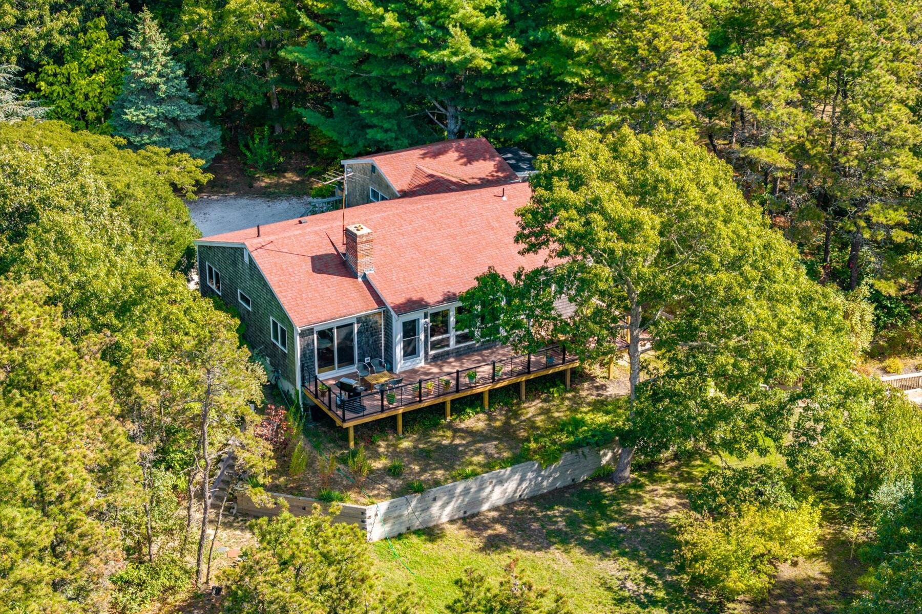 225 Coles Neck Road Wellfleet, MA 02667 - Photo 2 of 51 an aerial view of a house with a yard large trees