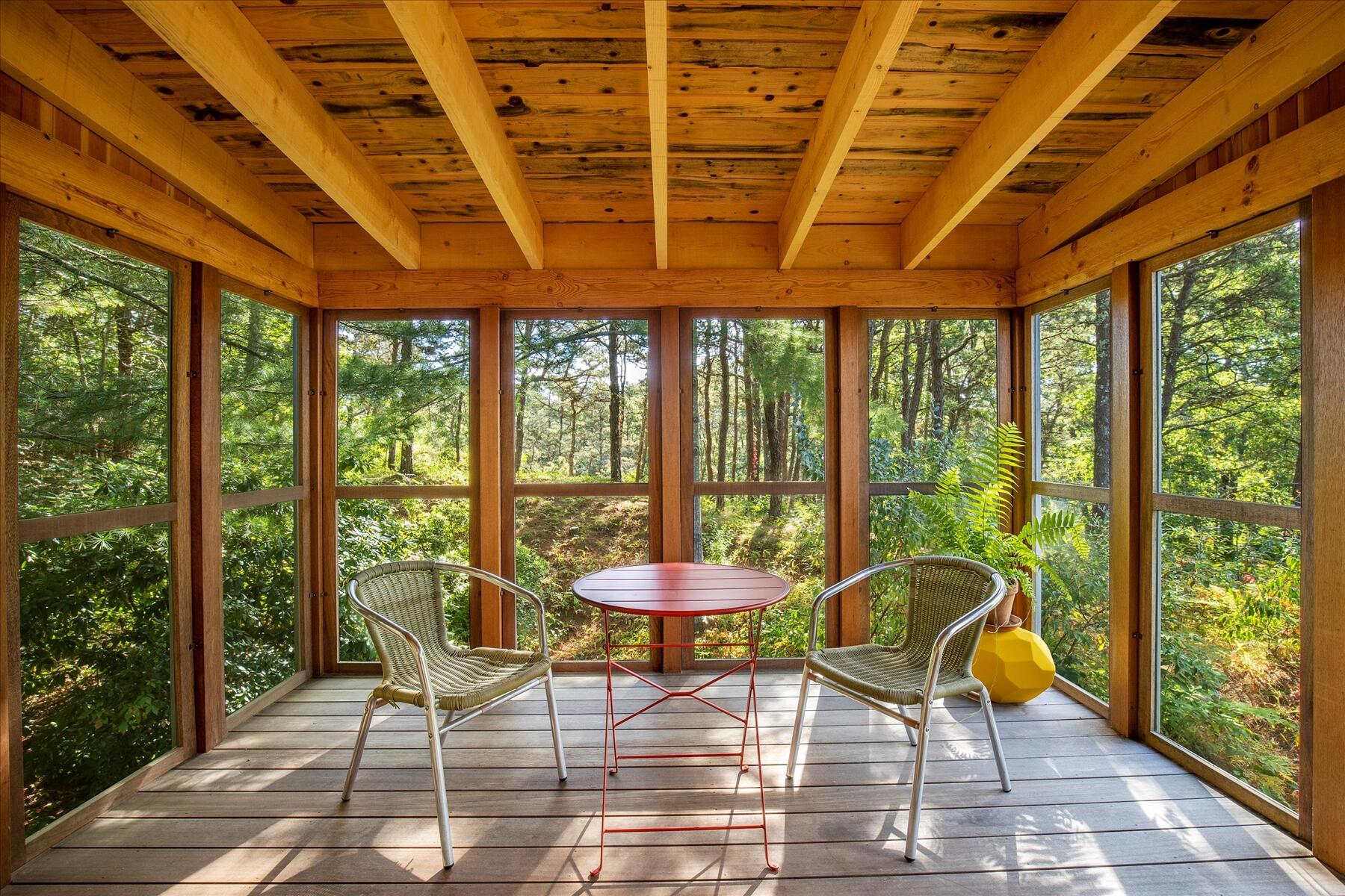 225 Coles Neck Road Wellfleet, MA 02667 - Photo 23 of 51 a patio with glass top table and chairs