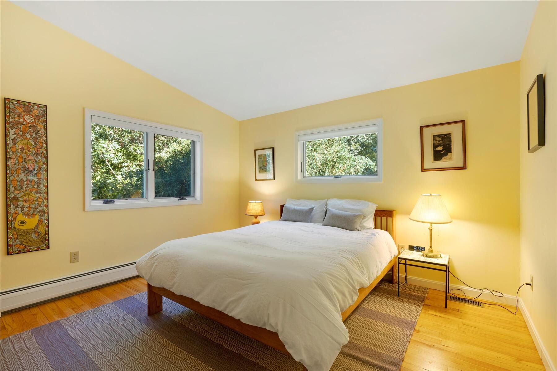 225 Coles Neck Road Wellfleet, MA 02667 - Photo 27 of 51 a bedroom with a bed and wooden floor