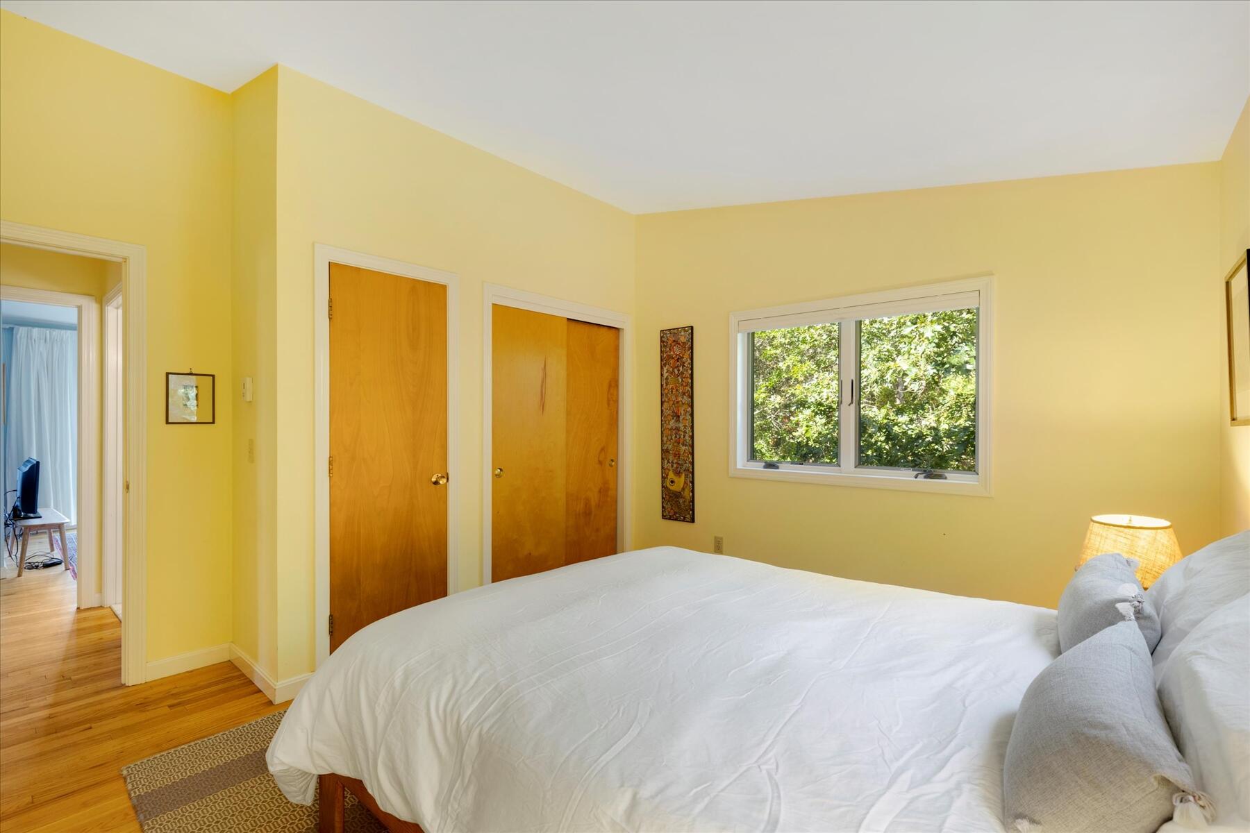 225 Coles Neck Road Wellfleet, MA 02667 - Photo 28 of 51 a bedroom with a bed and wooden floor