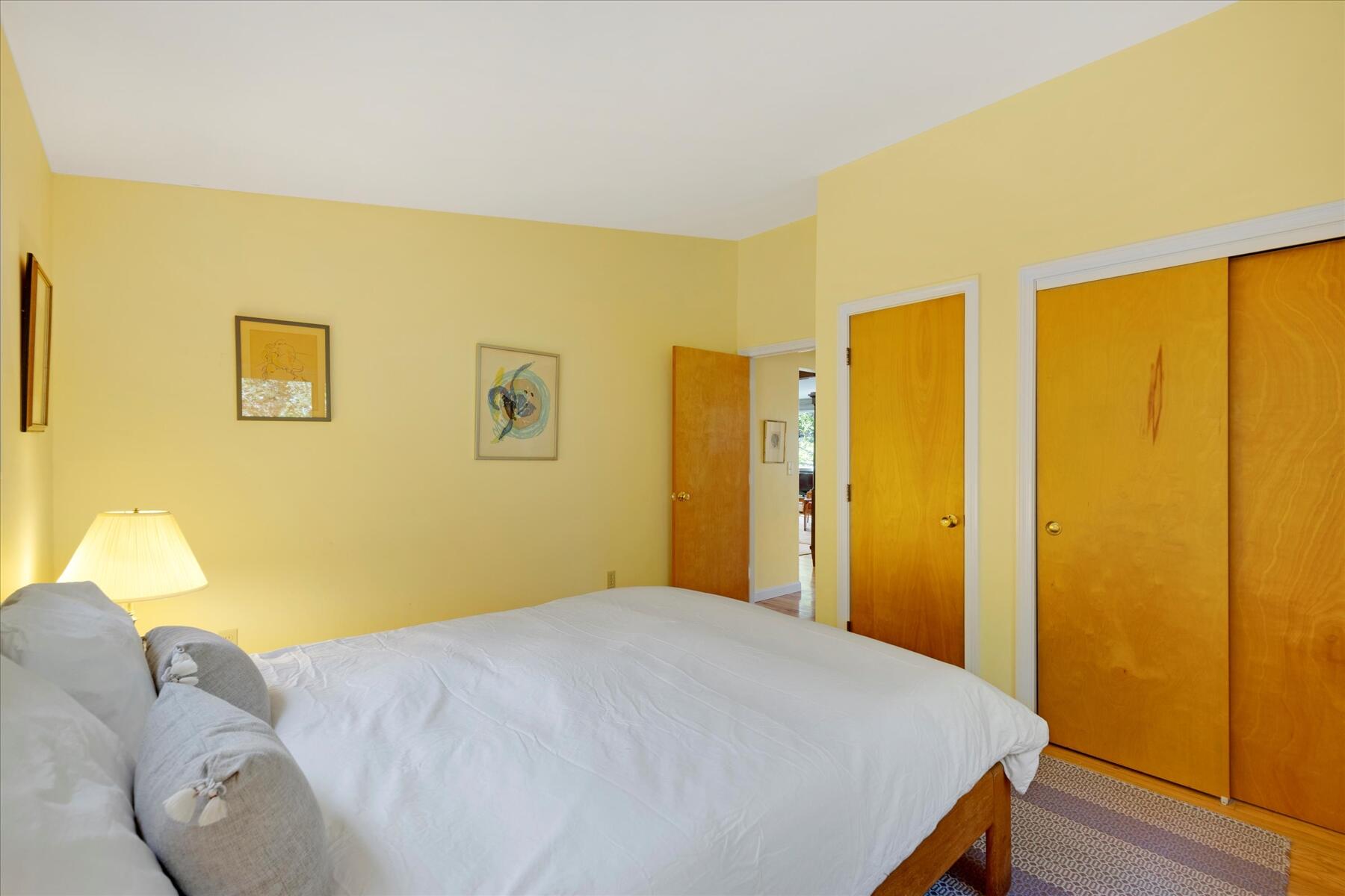 225 Coles Neck Road Wellfleet, MA 02667 - Photo 29 of 51 a bedroom with a bed and wooden floor