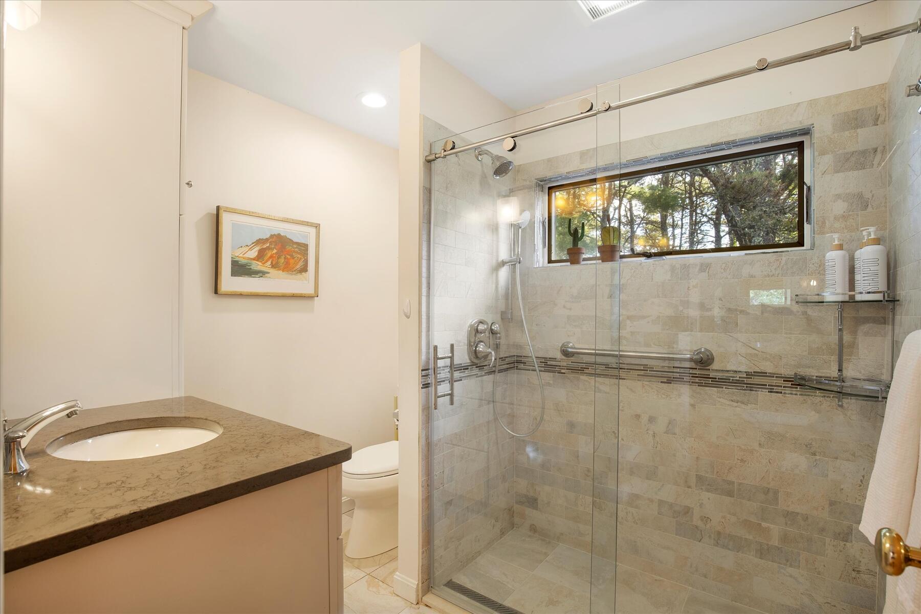 225 Coles Neck Road Wellfleet, MA 02667 - Photo 31 of 51 a bathroom with a granite countertop sink mirror vanity and toilet