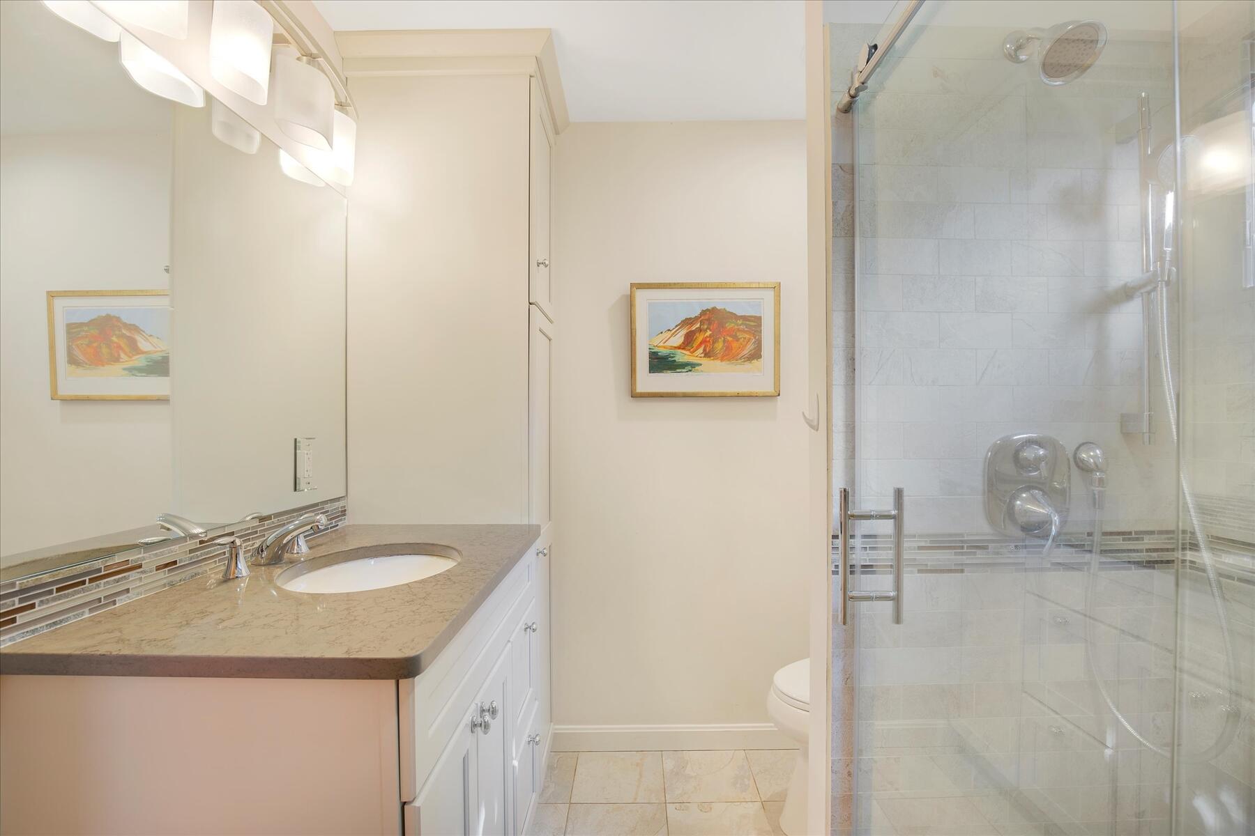 225 Coles Neck Road Wellfleet, MA 02667 - Photo 32 of 51 a bathroom with a granite countertop sink a mirror and vanity