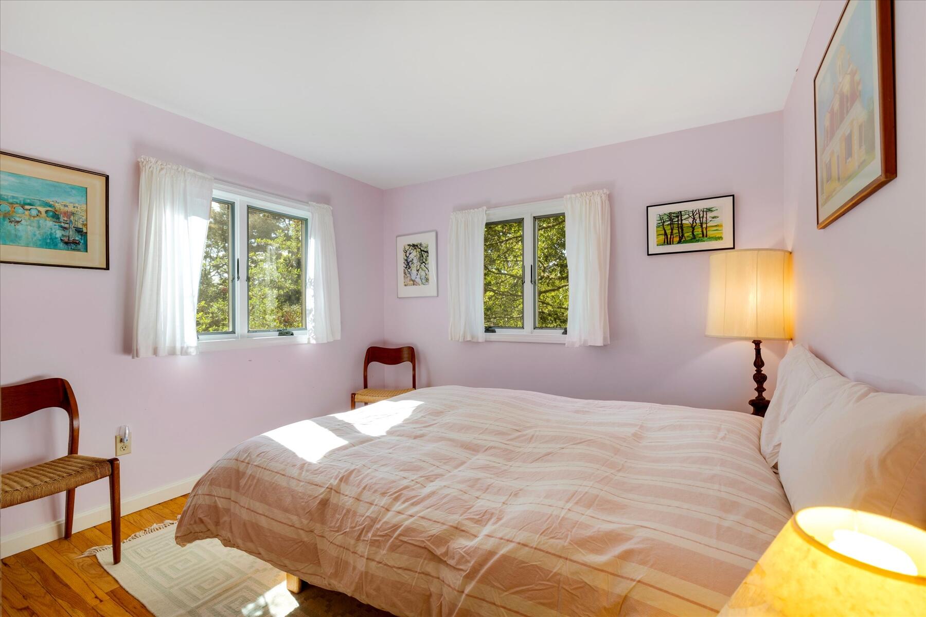 225 Coles Neck Road Wellfleet, MA 02667 - Photo 35 of 51 a bedroom with a bed and a lamp next to a window