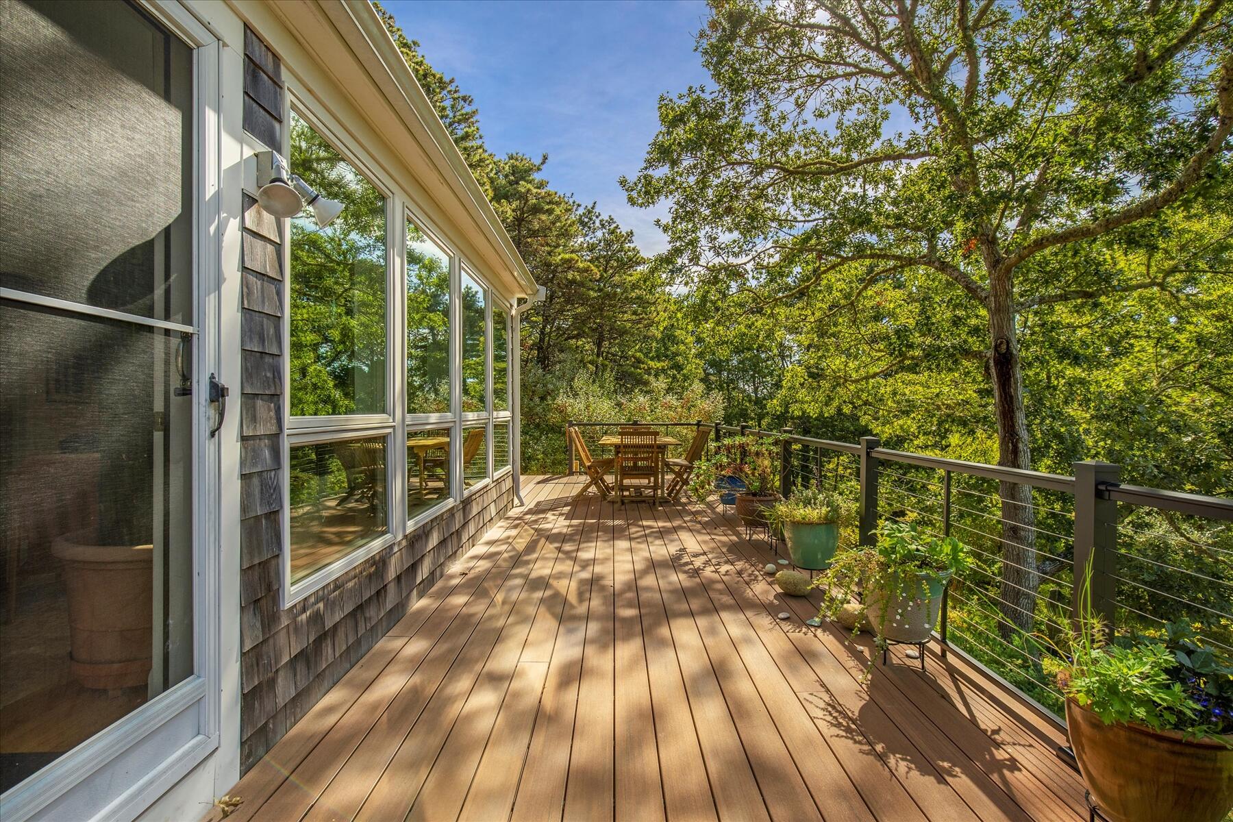 225 Coles Neck Road Wellfleet, MA 02667 - Photo 42 of 51 a view of balcony with a large window and wooden floor