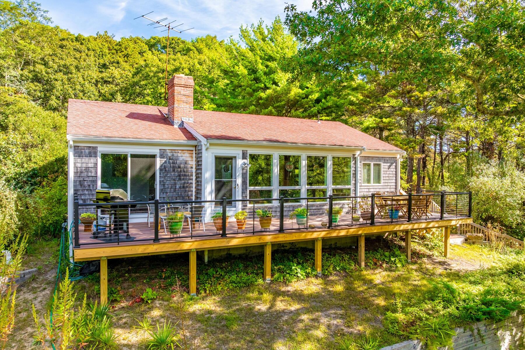 225 Coles Neck Road Wellfleet, MA 02667 - Photo 45 of 51 a house with swimming pool in front of it