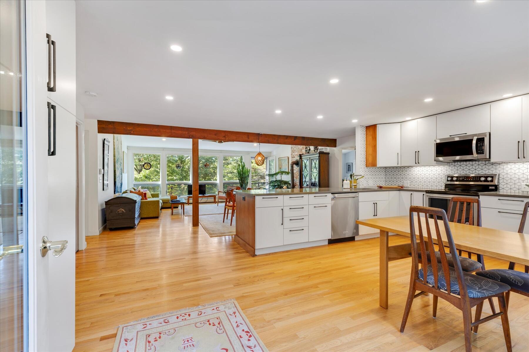 225 Coles Neck Road Wellfleet, MA 02667 - Photo 10 of 51 a kitchen with stainless steel appliances a dining table chairs and granite counter tops