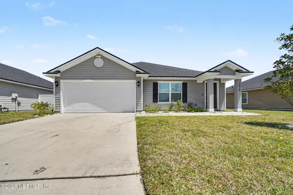 a front view of a house with a yard