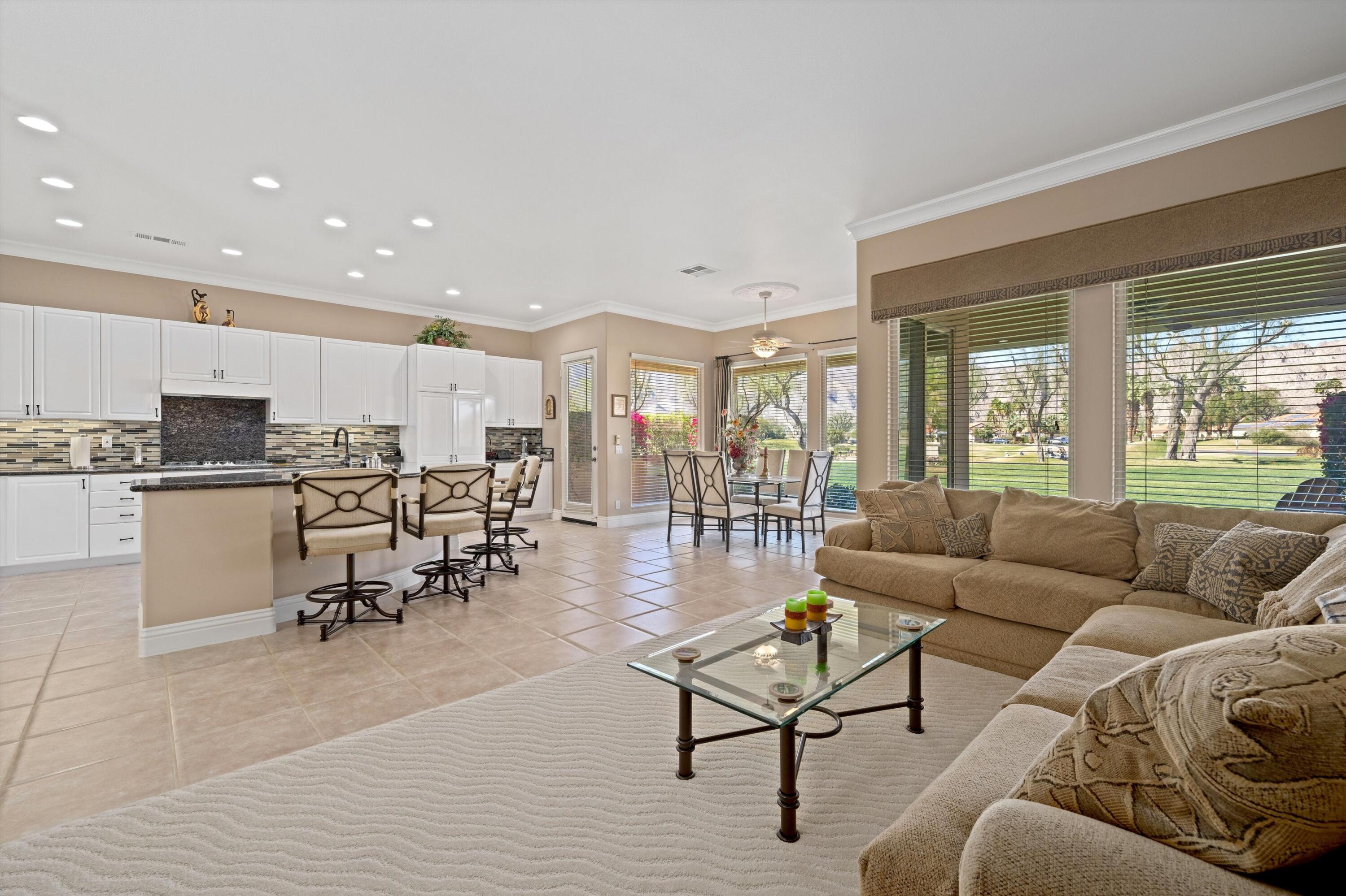 57255 Interlachen La Quinta, CA 92253 - Photo 19 of 34 a living room kitchen with furniture and a large window