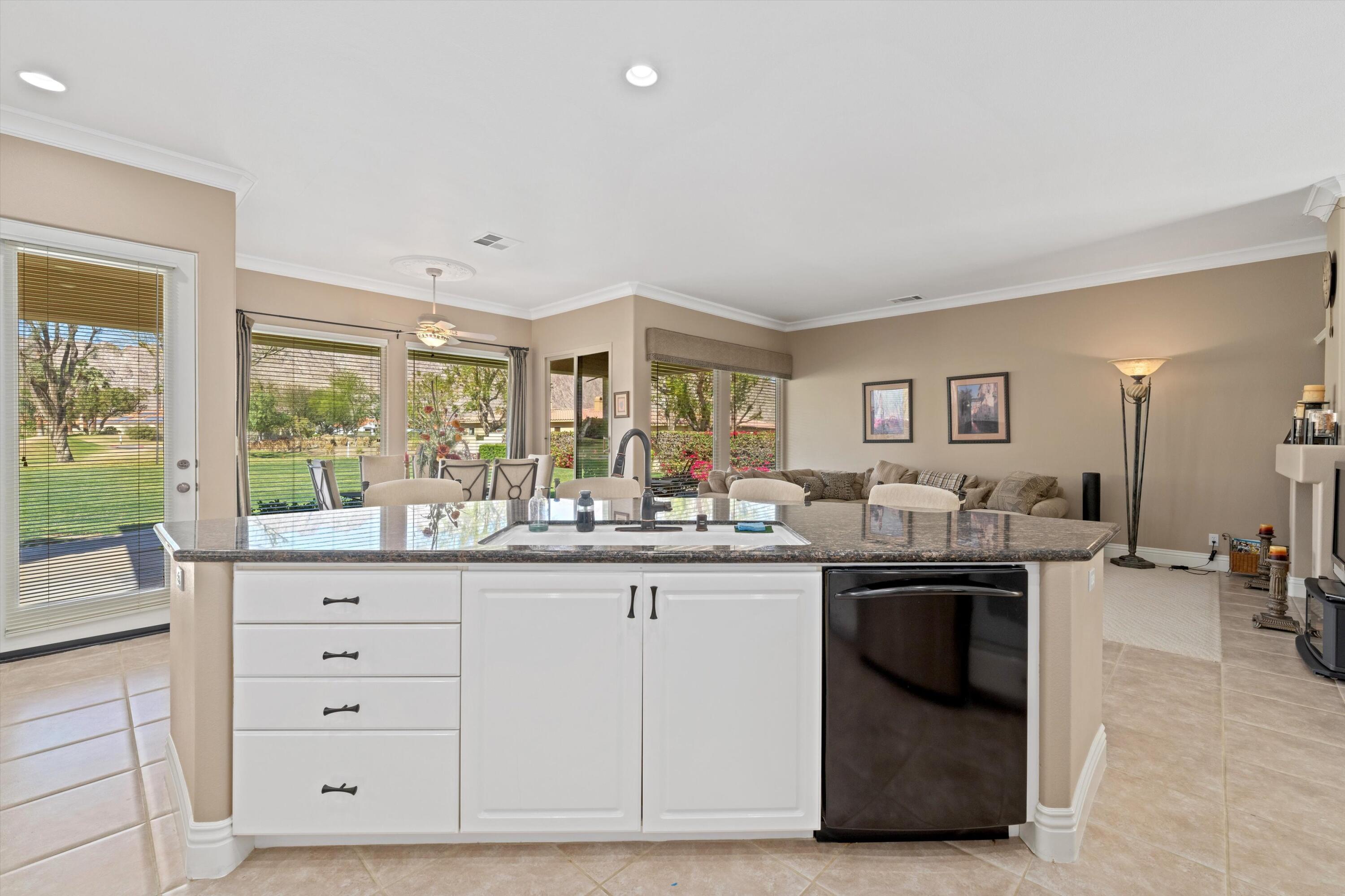 57255 Interlachen La Quinta, CA 92253 - Photo 23 of 34 a kitchen with granite countertop a sink and cabinets