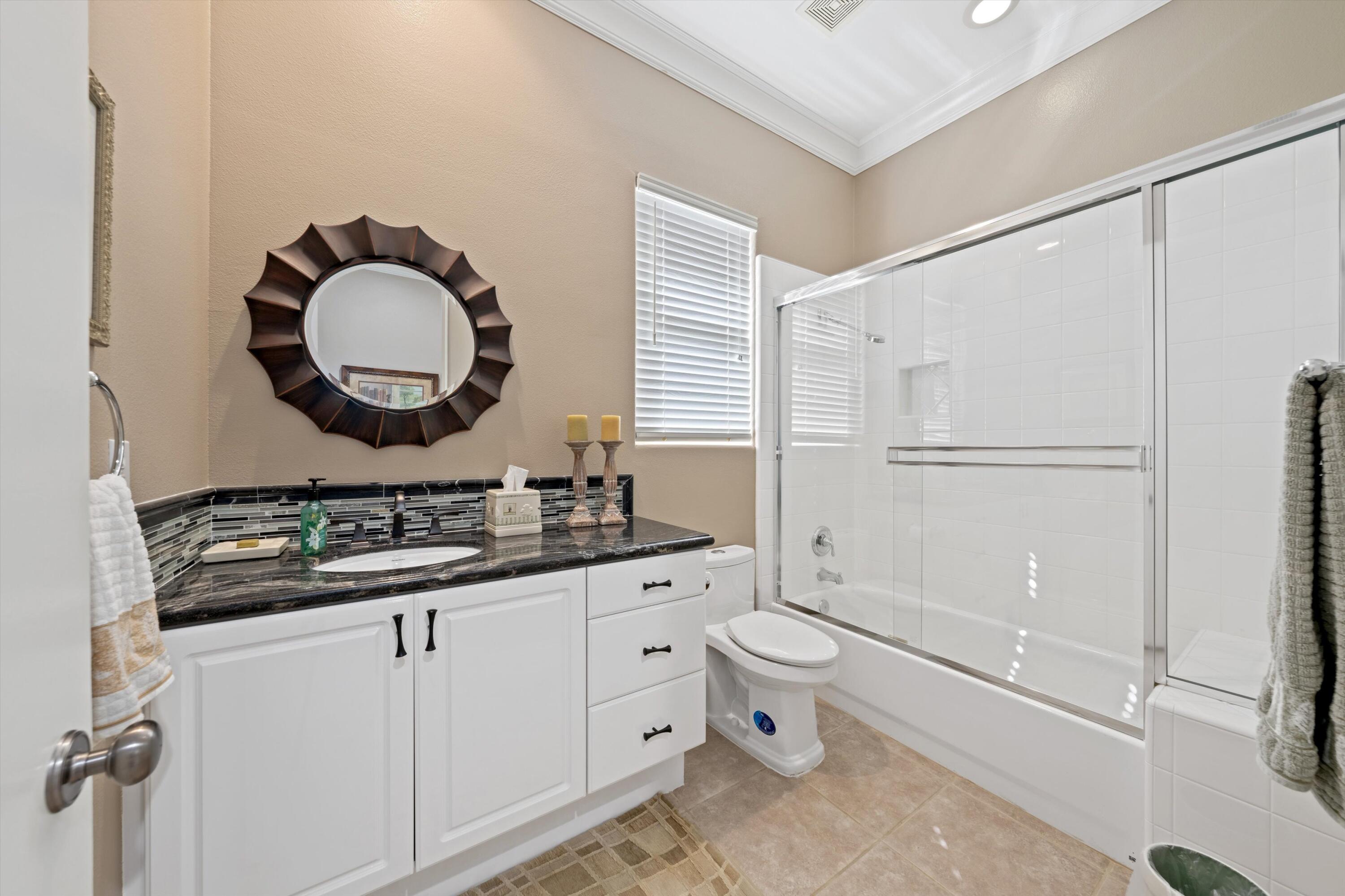 57255 Interlachen La Quinta, CA 92253 - Photo 25 of 34 a bathroom with a toilet a sink and a mirror