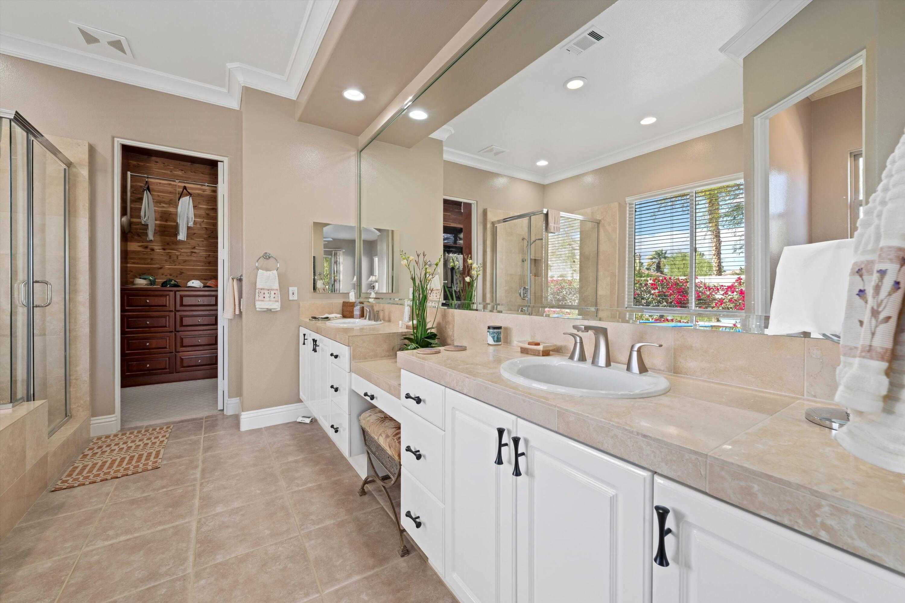 57255 Interlachen La Quinta, CA 92253 - Photo 29 of 34 a spacious bathroom with a double vanity sink a mirror and a shower