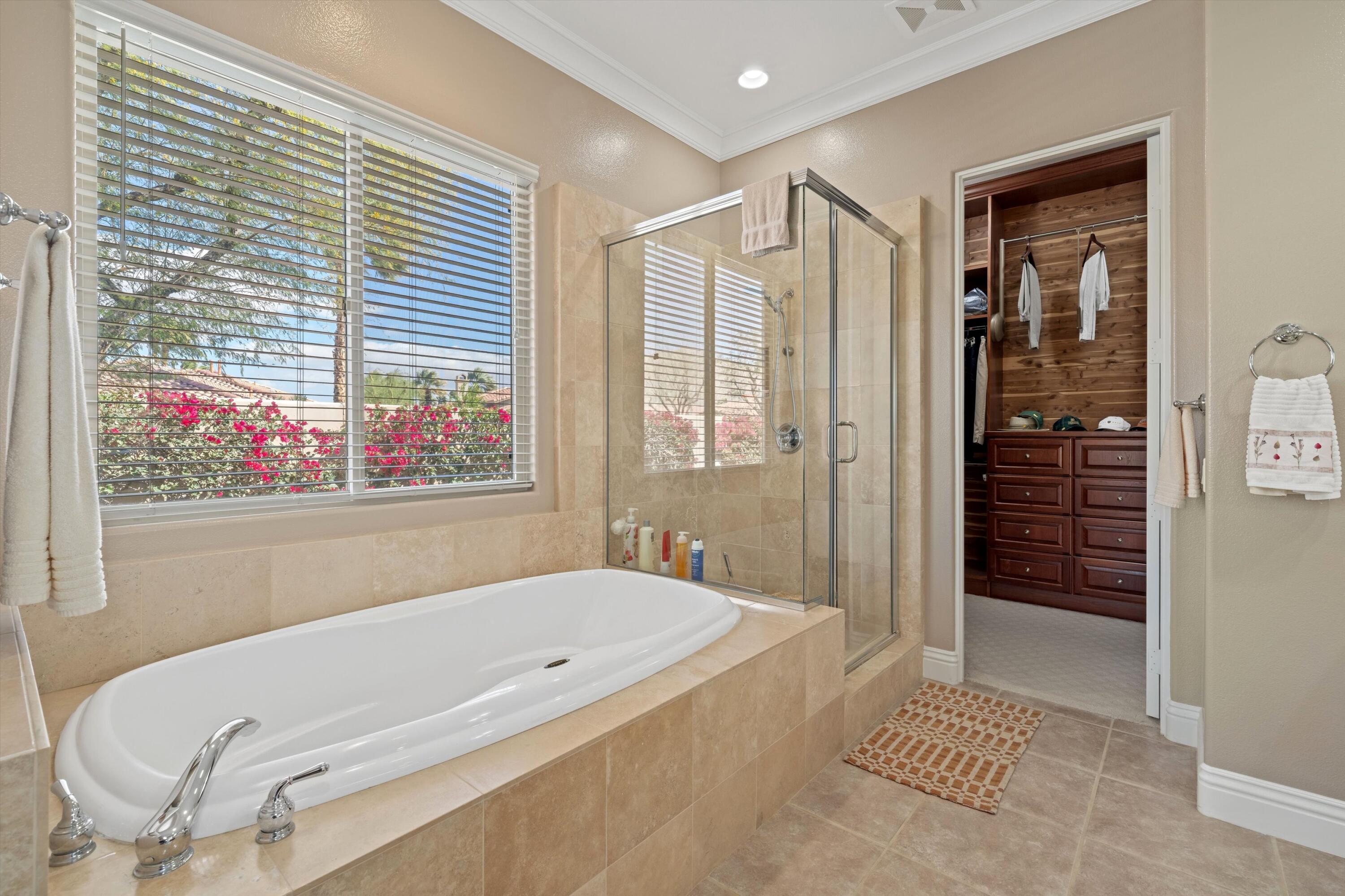 57255 Interlachen La Quinta, CA 92253 - Photo 30 of 34 a bathroom with a tub and shower