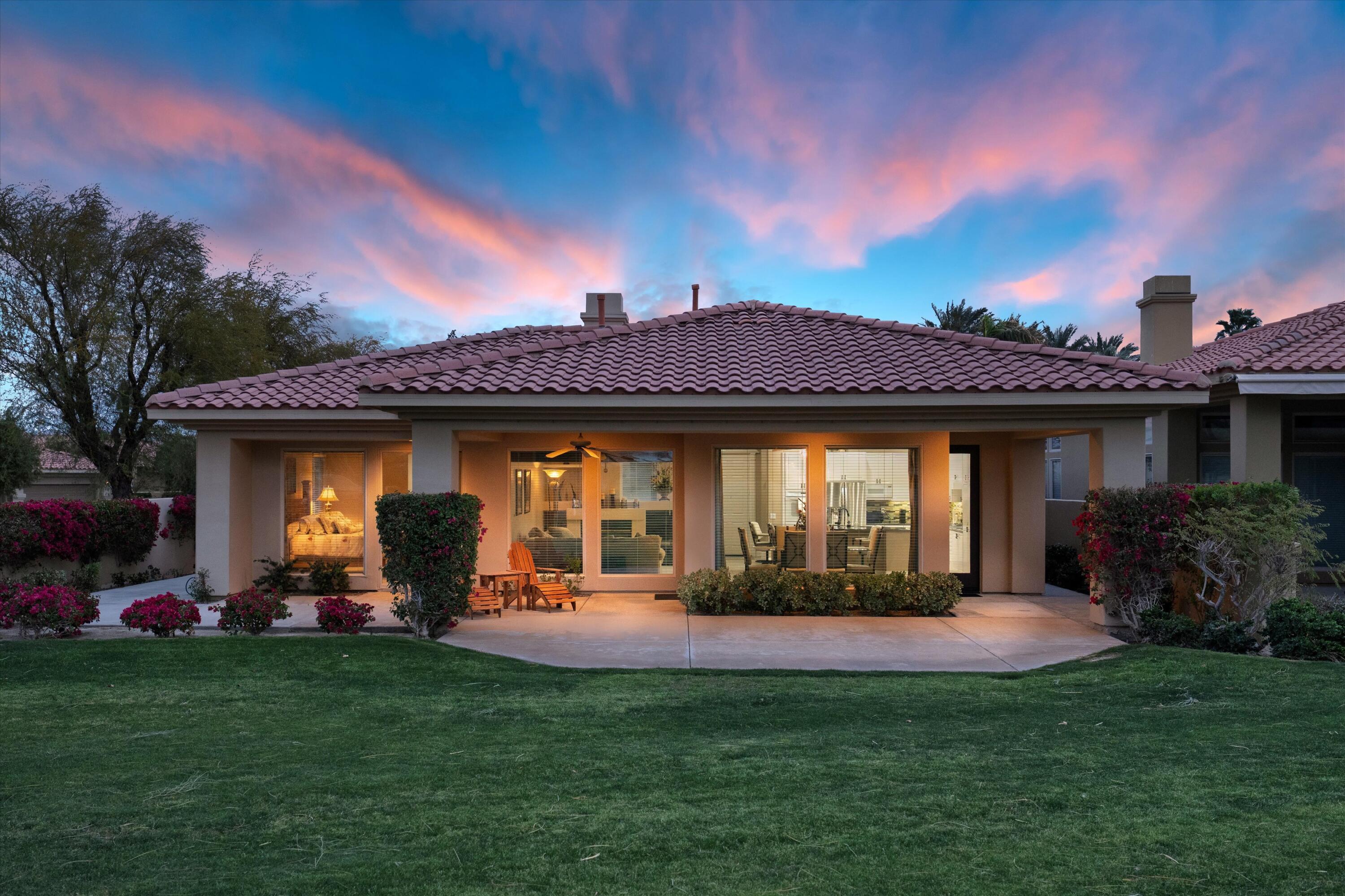 57255 Interlachen La Quinta, CA 92253 - Photo 3 of 34 a view of a house with a yard fire pit and a large tree