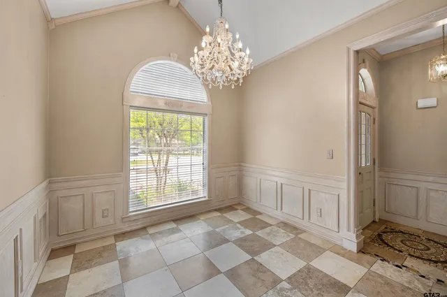 a large room with windows and chandelier