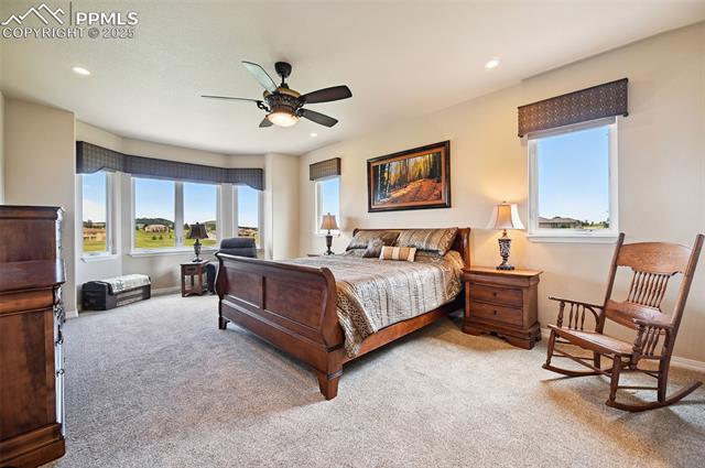 1918 Bashley Road Monument, CO 80132 - Photo 21 of 48 Bedroom featuring light colored carpet, recessed lighting, and a ceiling fan